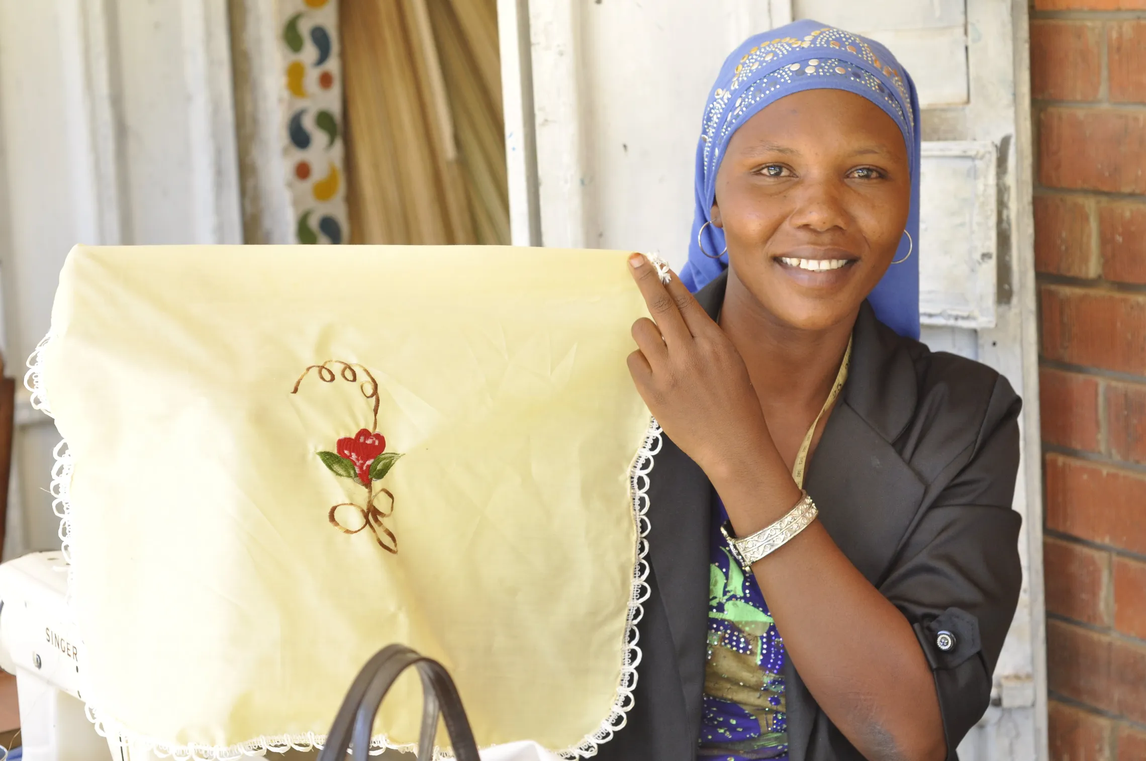 Scovia displays one of her table cloth pieces