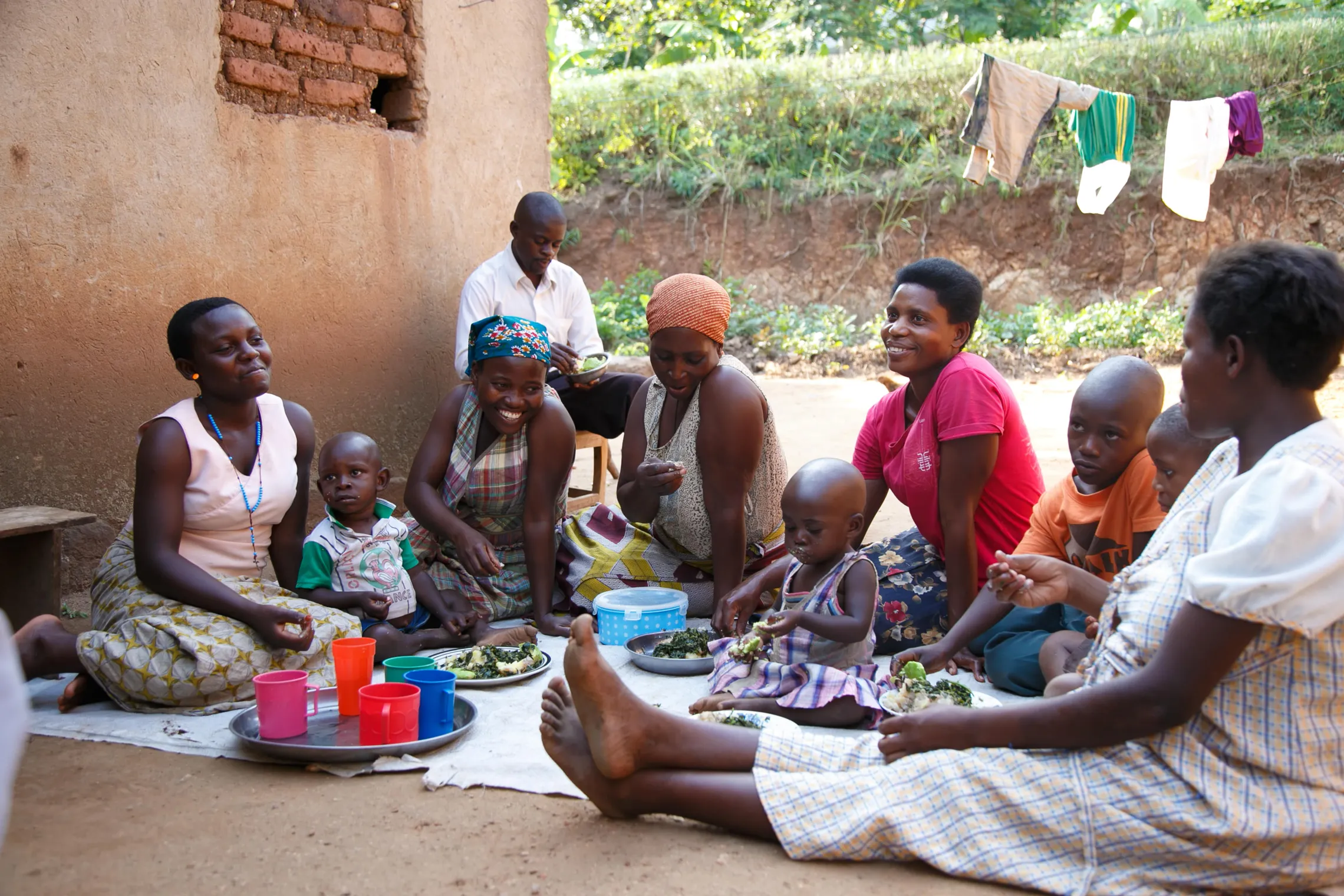 Yolesi (in pink blouse) having a nutritious meal with her family