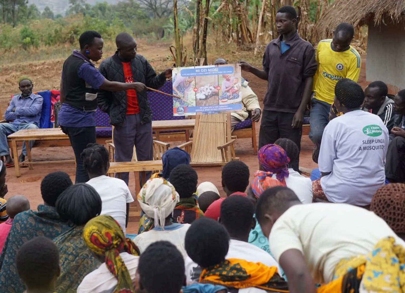 Health Assistant explains handwashing to Ayibu villagers in Uganda