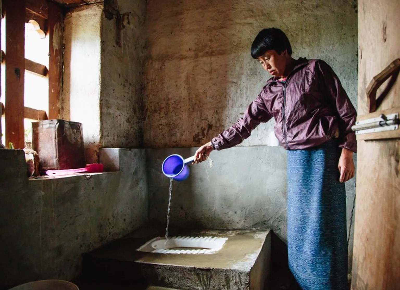 Clean and private toilet with water for flushing, Punakha district
