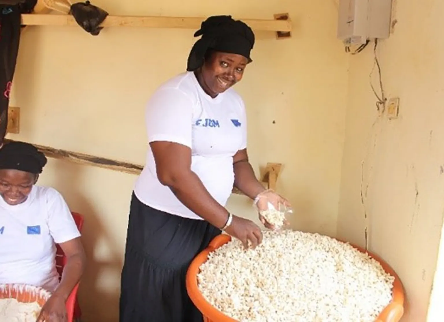 Mariam puts popcorn in bags to sell.
