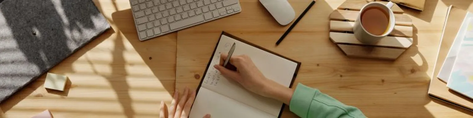 Person writing on notebook