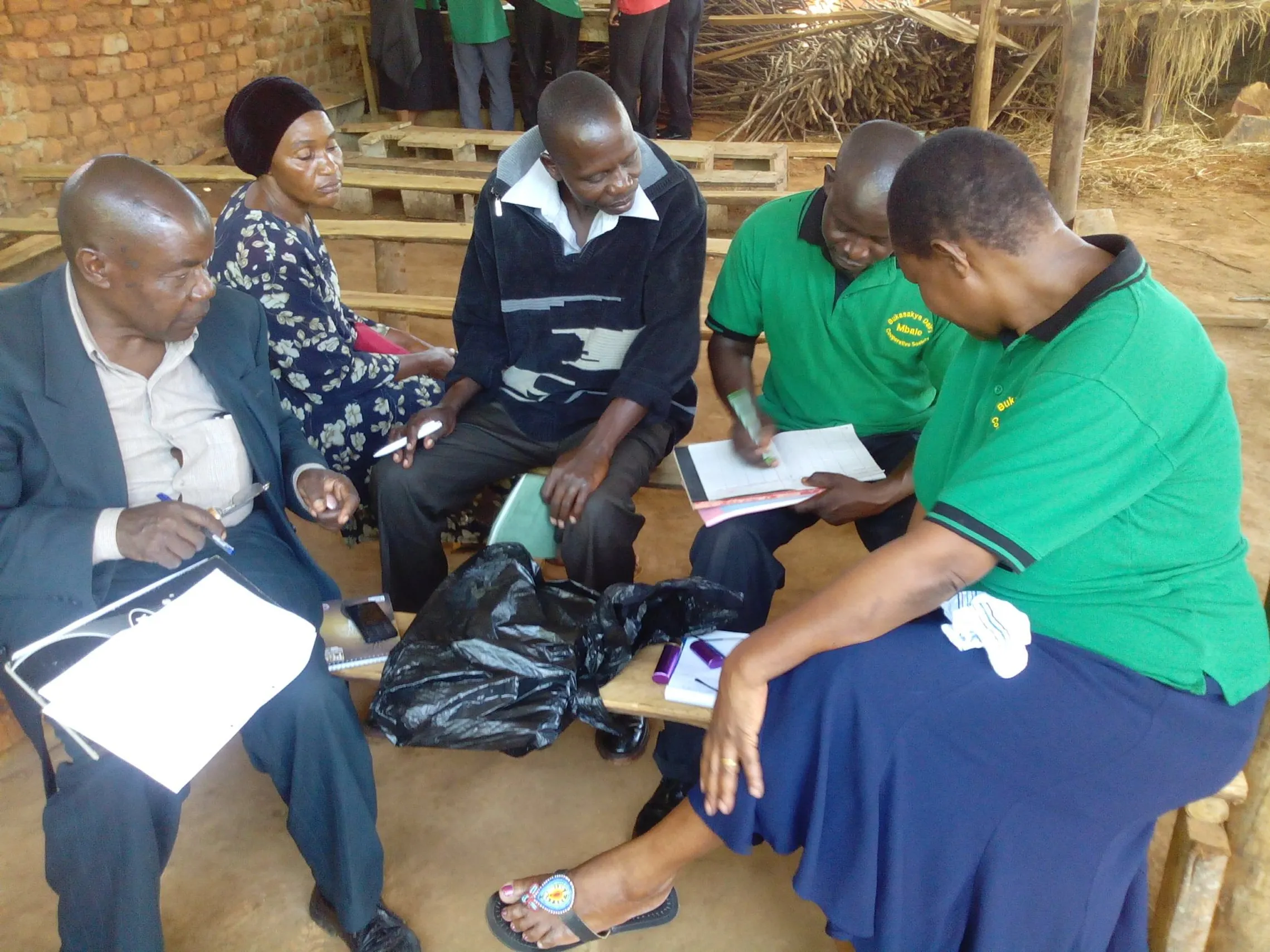 Wamalugo- left, and his friends learning about loans