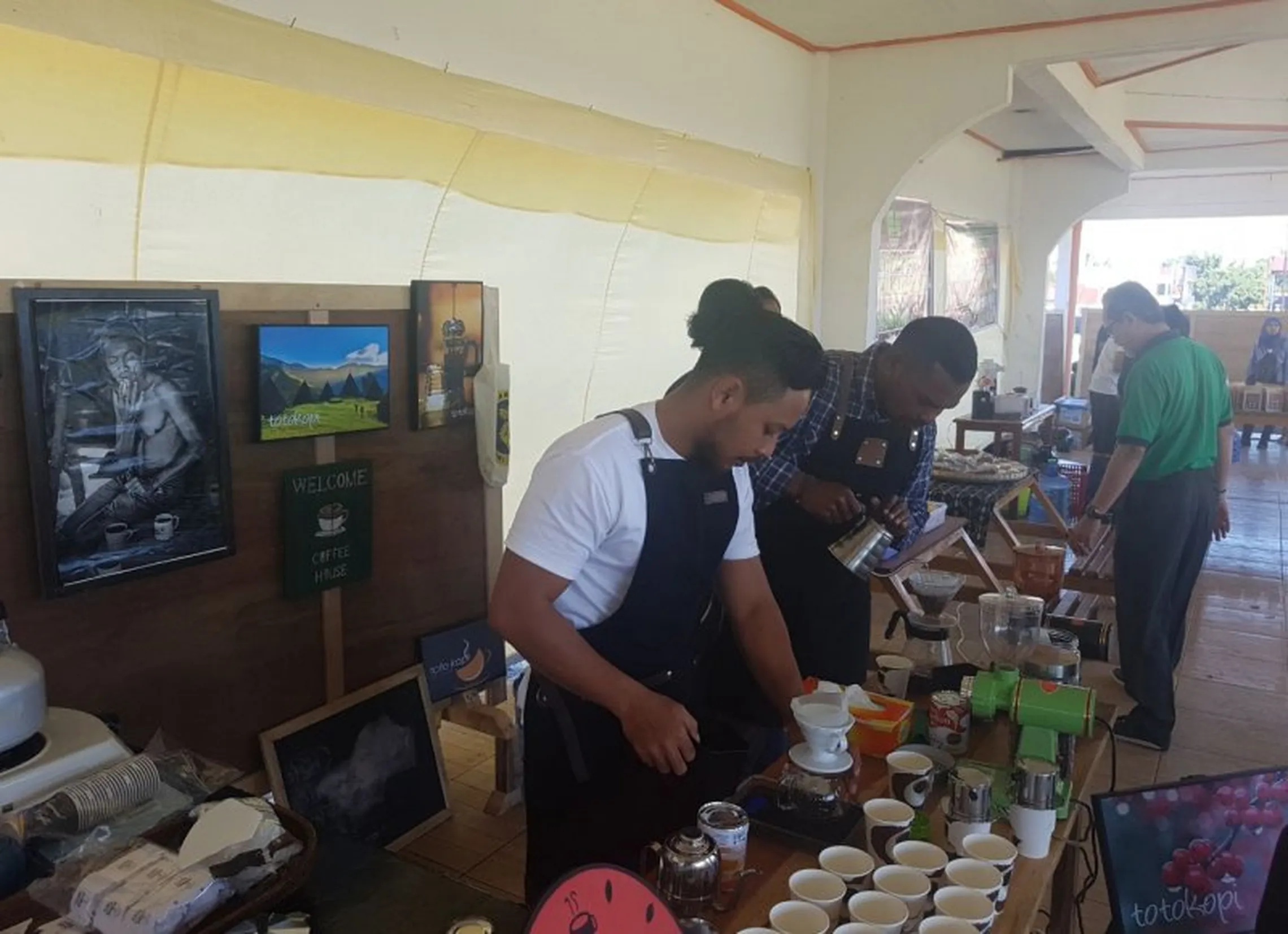 Baristas prepare fresh cups of coffee for festival visitors