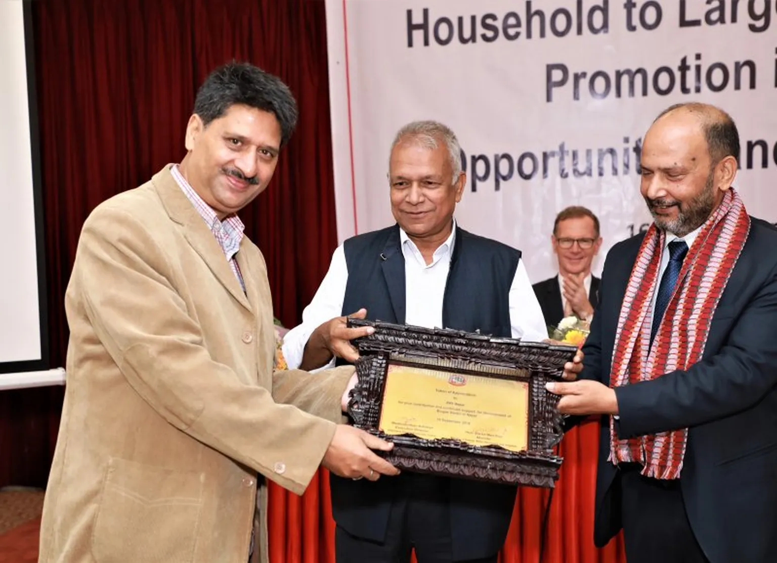 Mr. Dinesh Kumar Ghimire presents the award 
