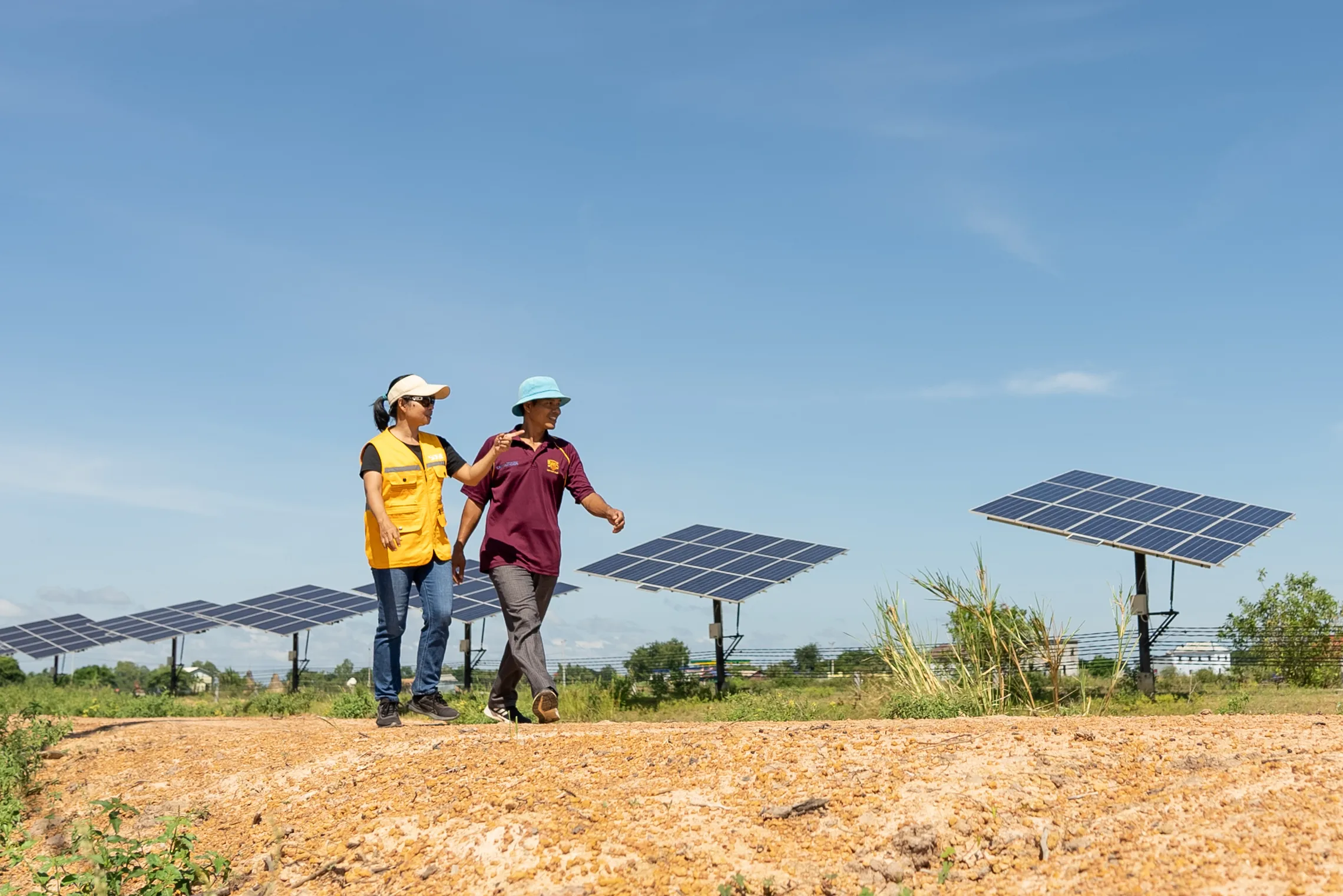 SOGE CEO walking past solar panels