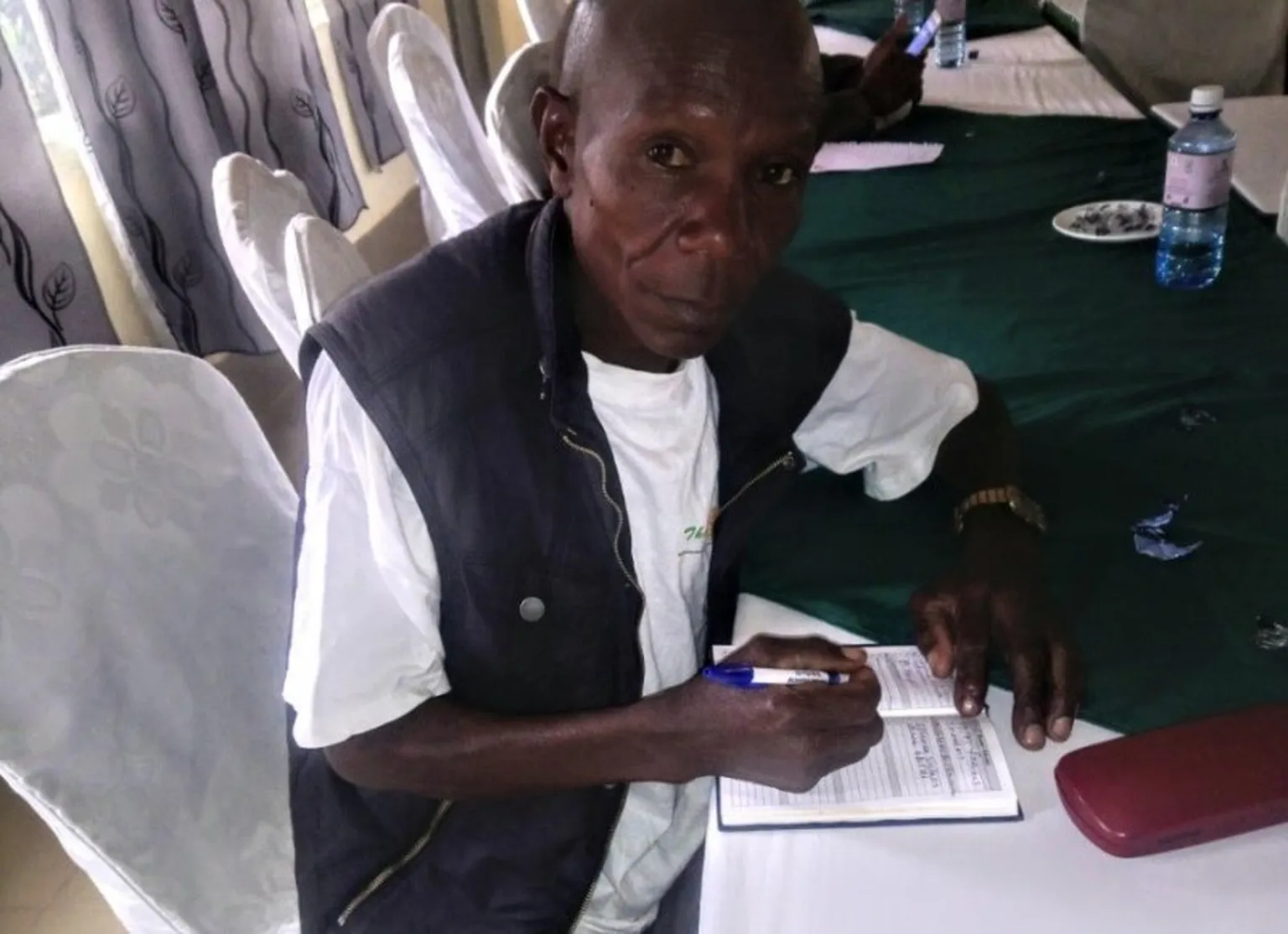 Munyoki taking notes during Kitui honey value chain forum