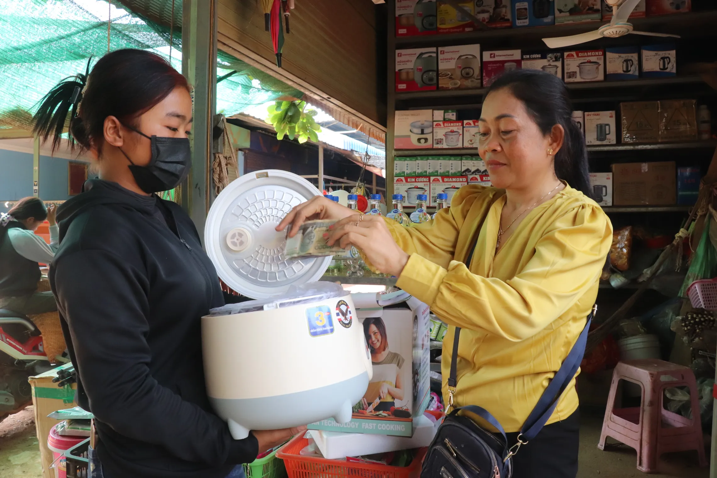 A woman selling a cooker