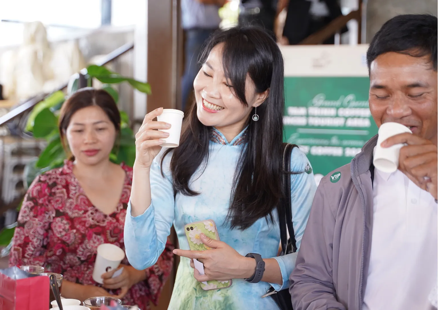 Photo of a woman and man tasting cup of coffee