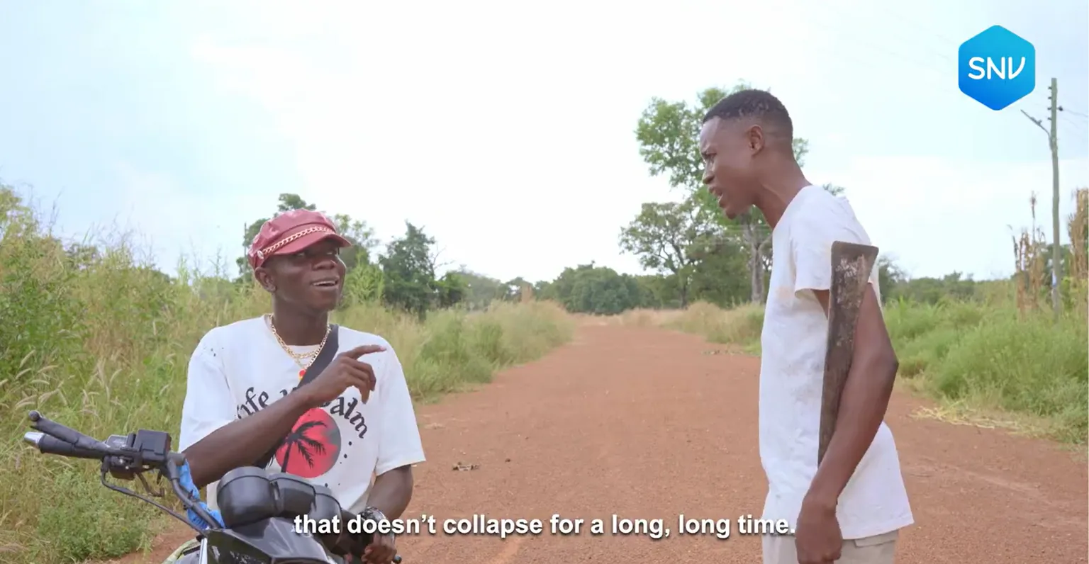 Two people chat on a dirt road, with one sitting on a motorcycle and the other holding a tool. Subtitles mention not collapsing for a long time.
