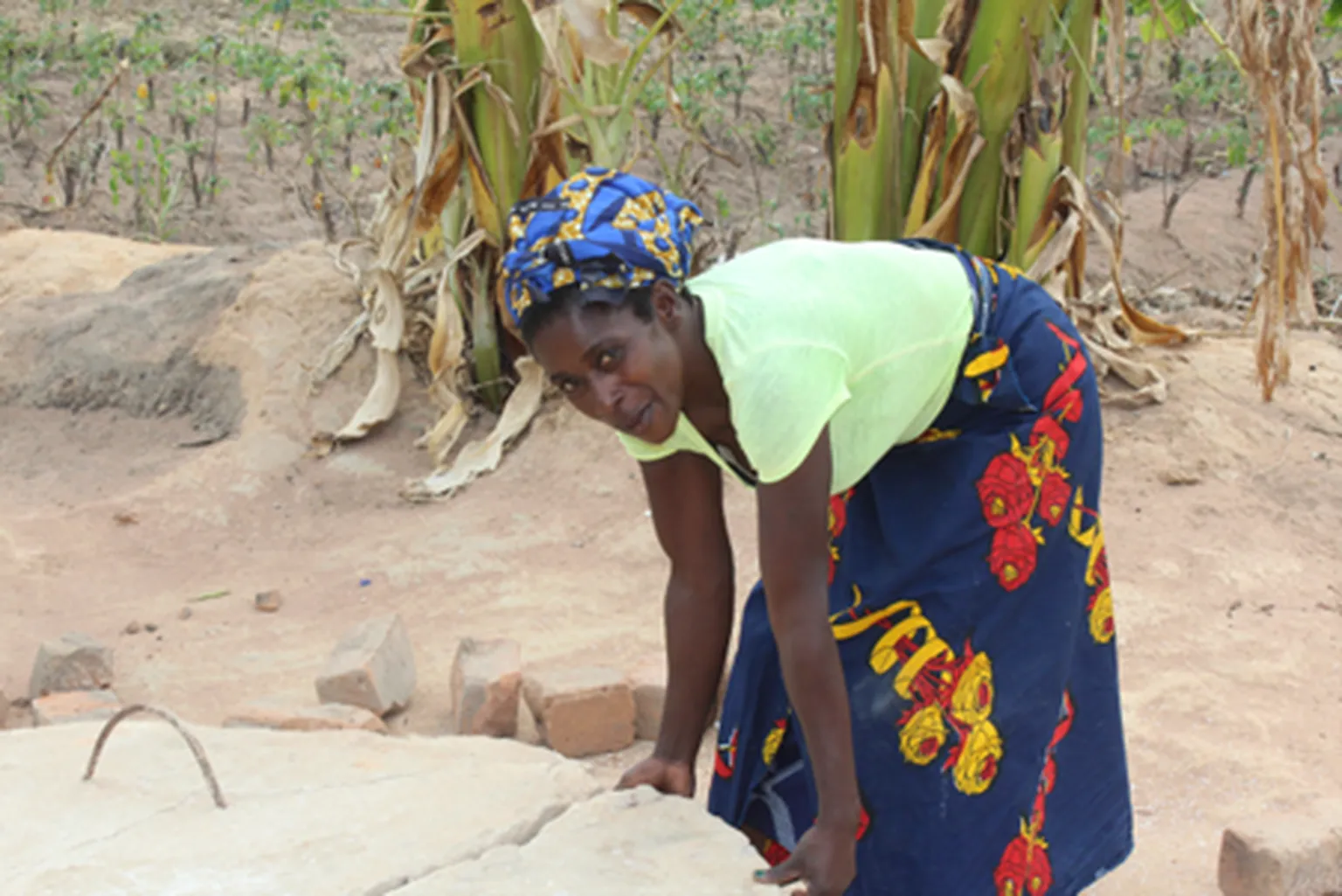 Irene tending to her biodigester 