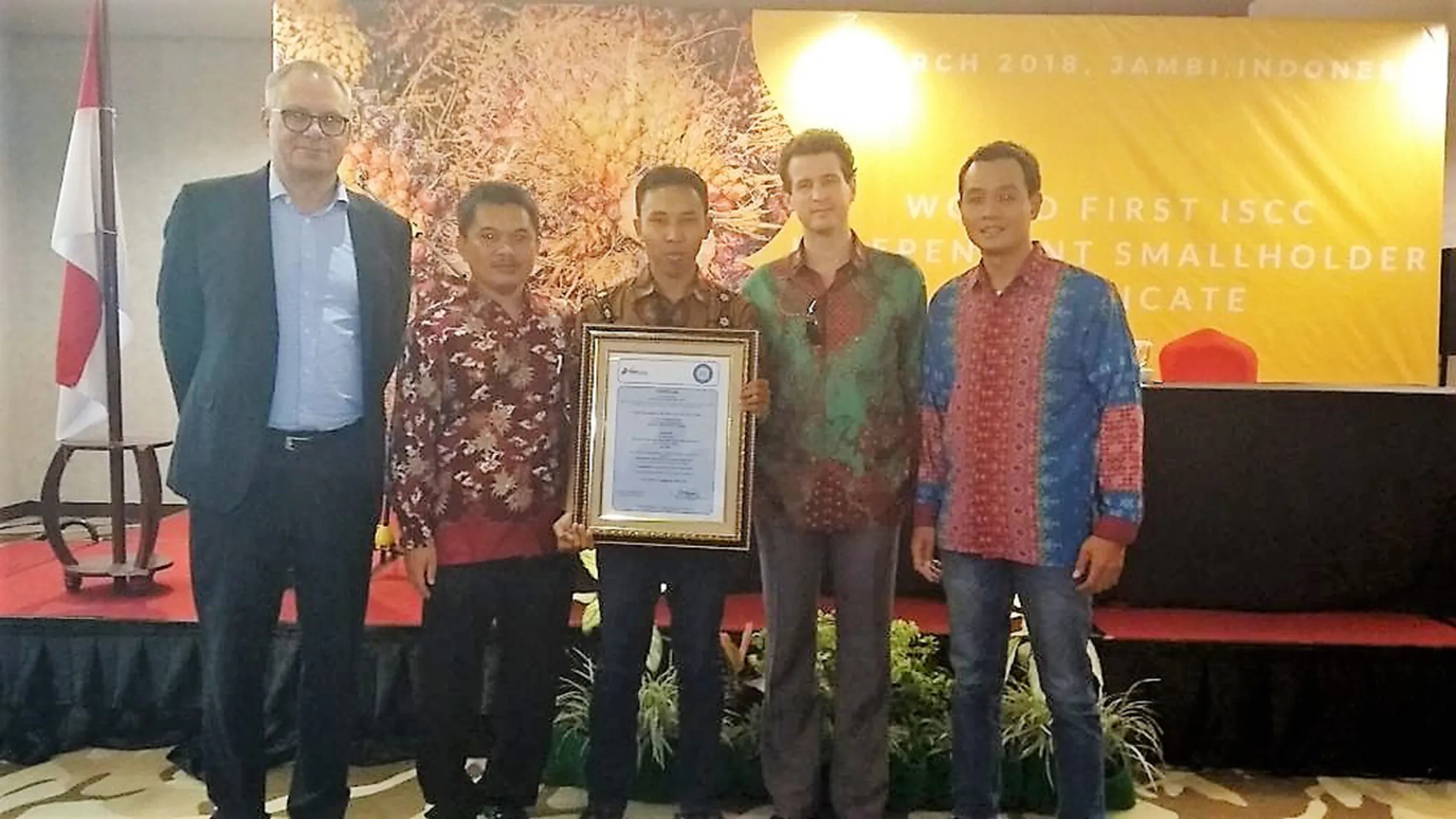 The first certificate is presented to palm oil farmers