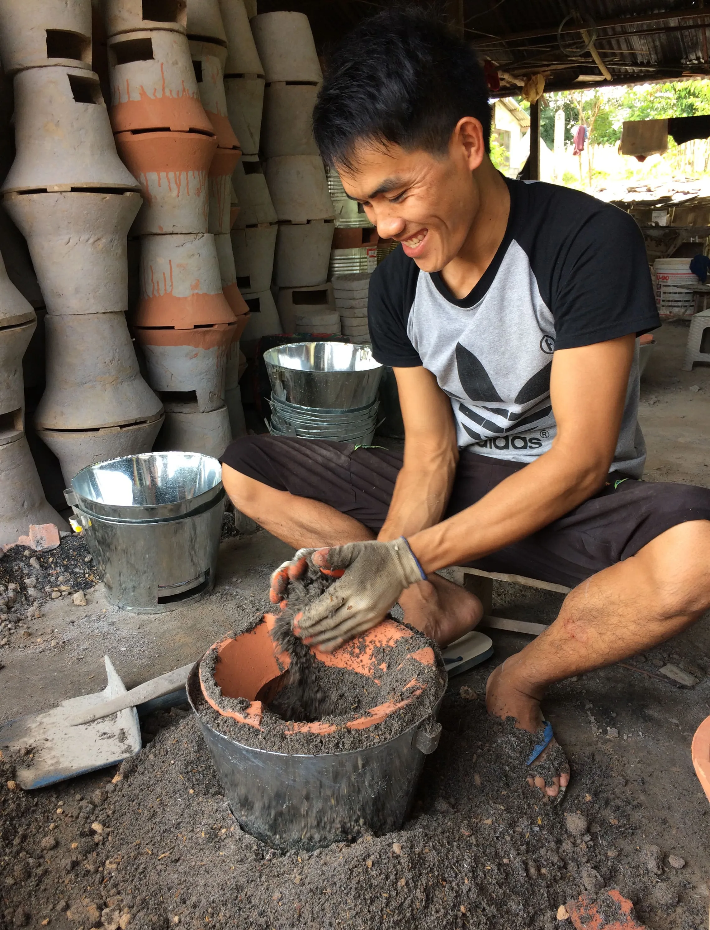 ICS Cookstove producer, Mr. Bounthieng, working on a cookstove