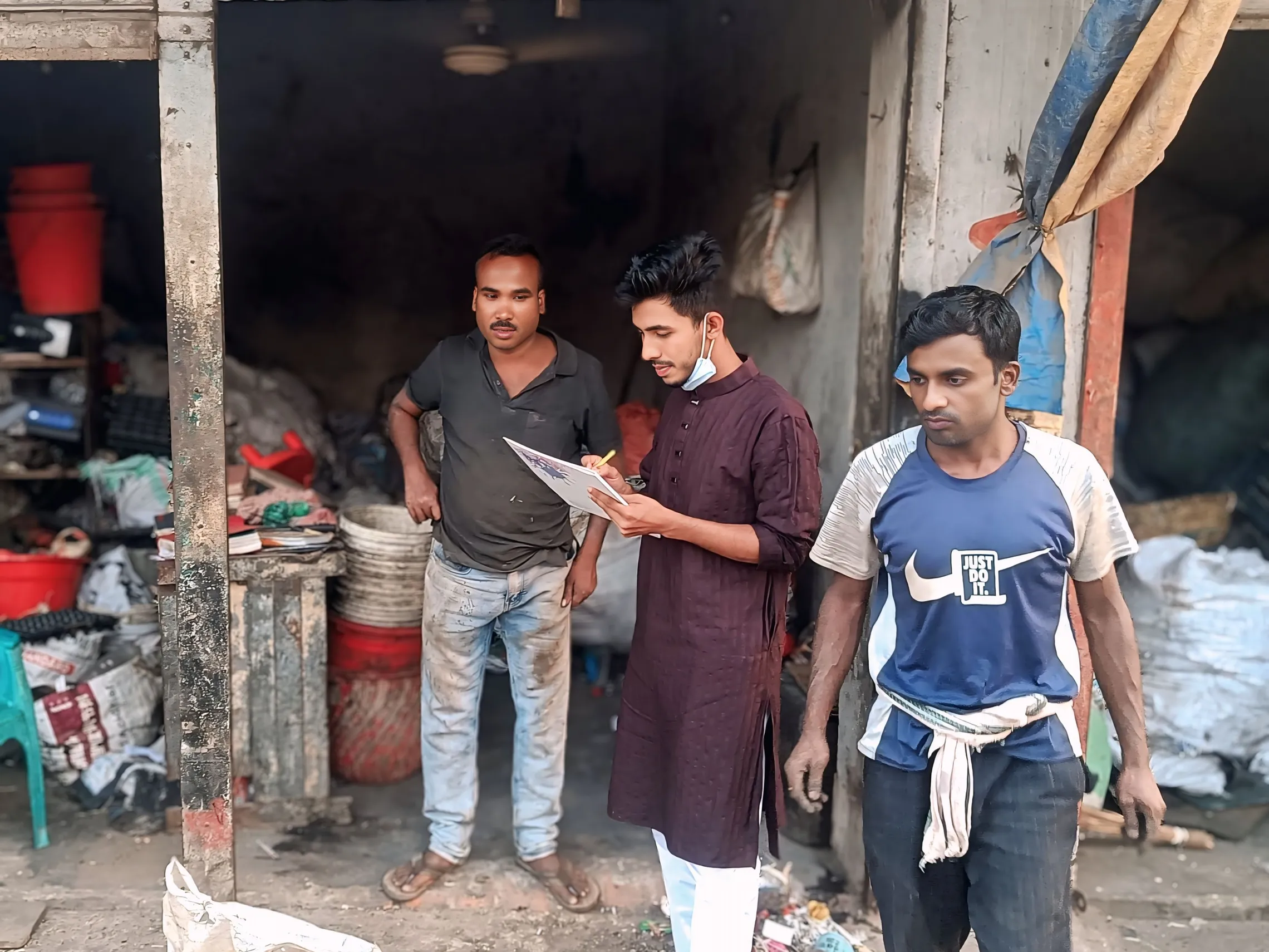 Youth volunteer gathers SWM data from a scrap dealer in Kushtia