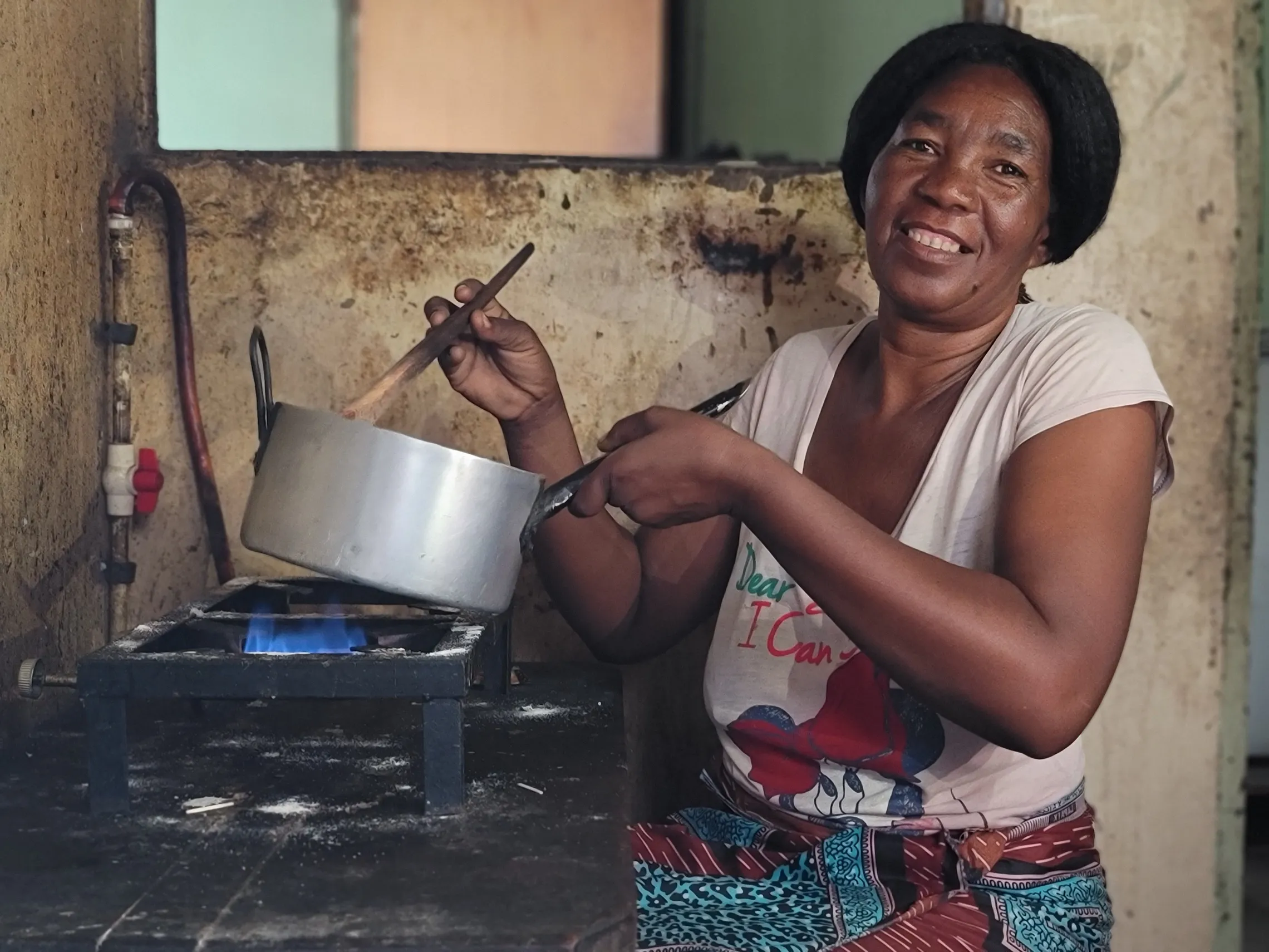 Woman cooking using biogas in Kenya