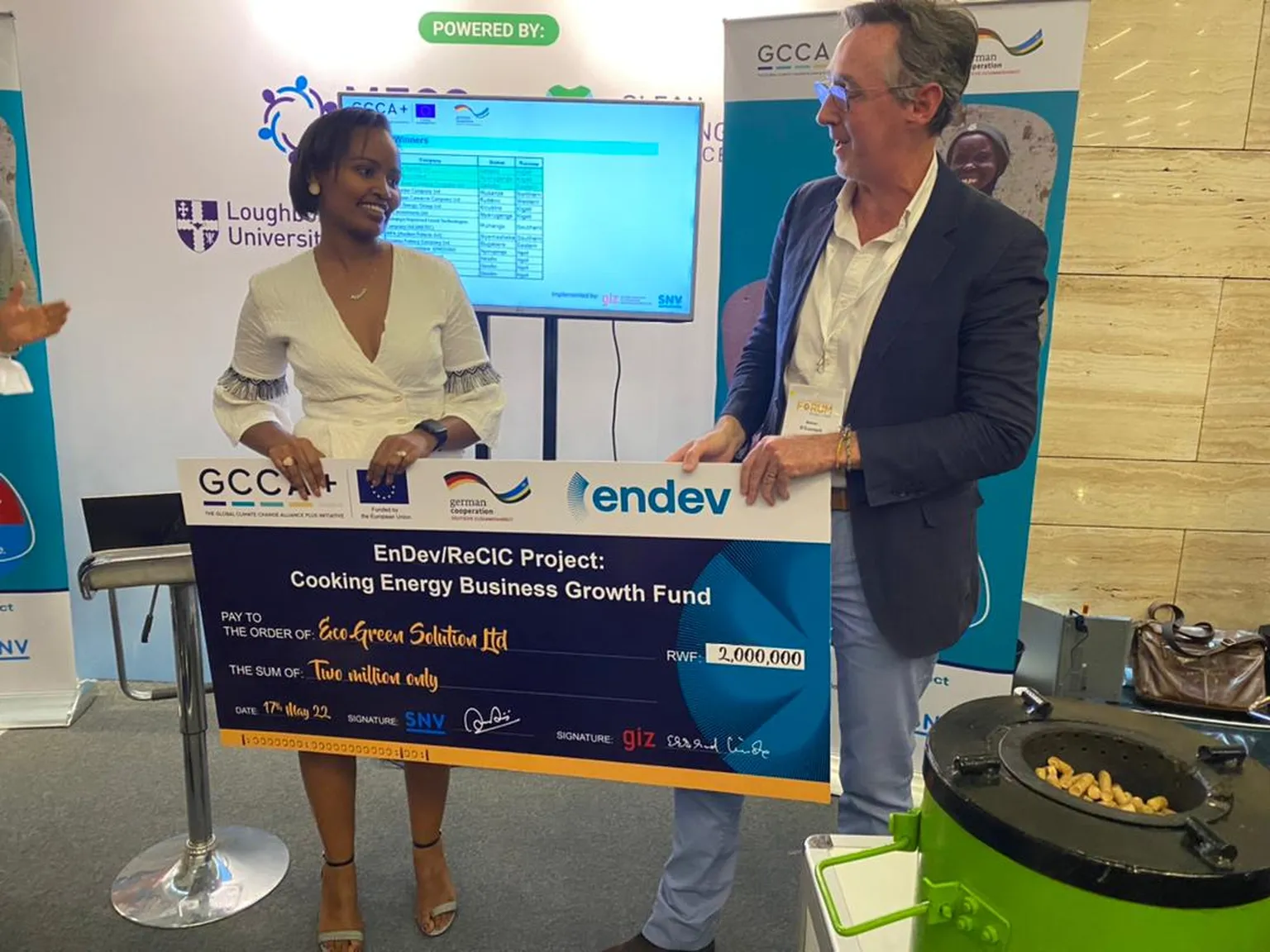 Simon O' Connell, SNV CEO presenting a cheque to the winner