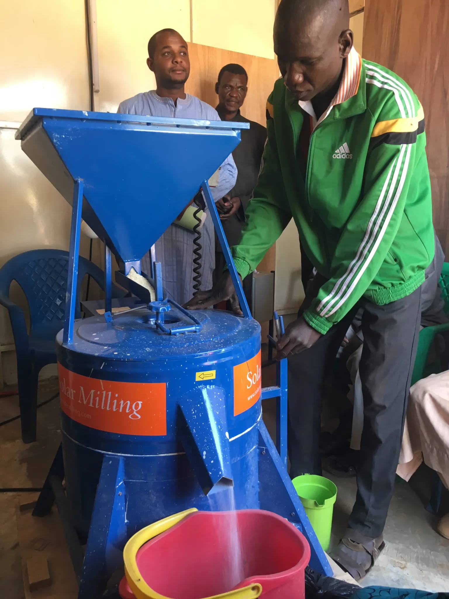 The GIMAFOR team using a solar-powered mill to process rice flour