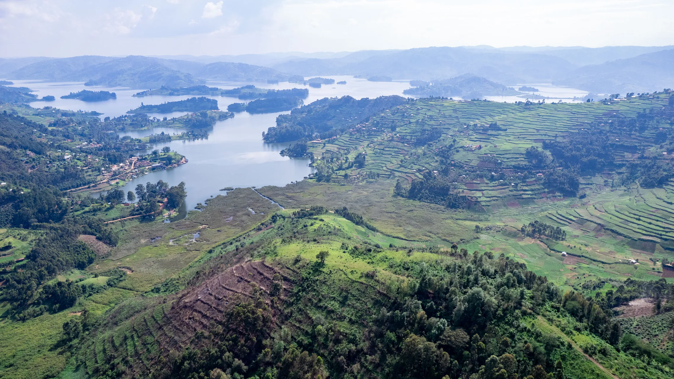 Drone footage of Kisoro District landscape in Uganda showing forest farms hills and lake
