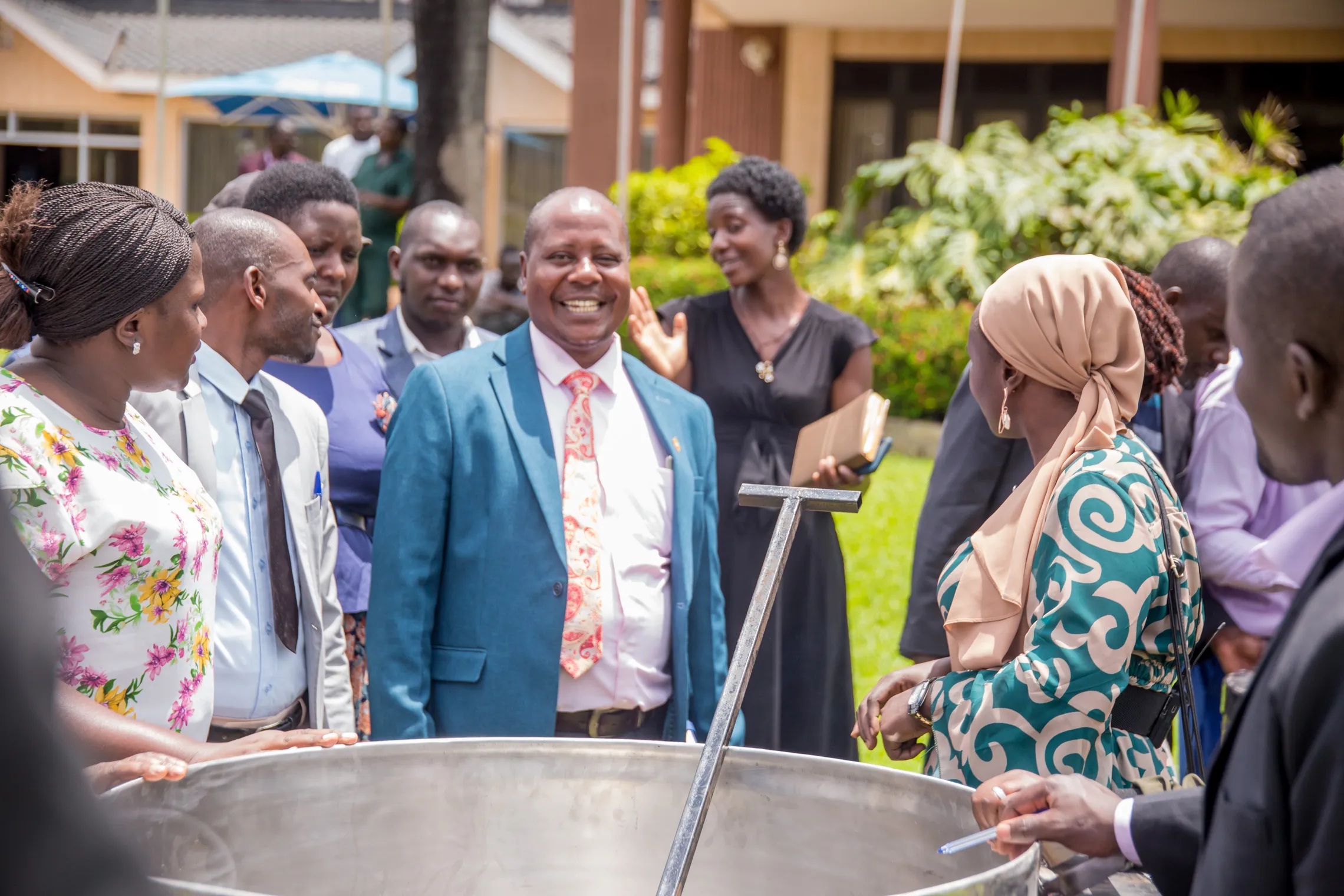 A group of Ugandan school feeding stakeholders gather to prepare the school meals in a school in Kampala