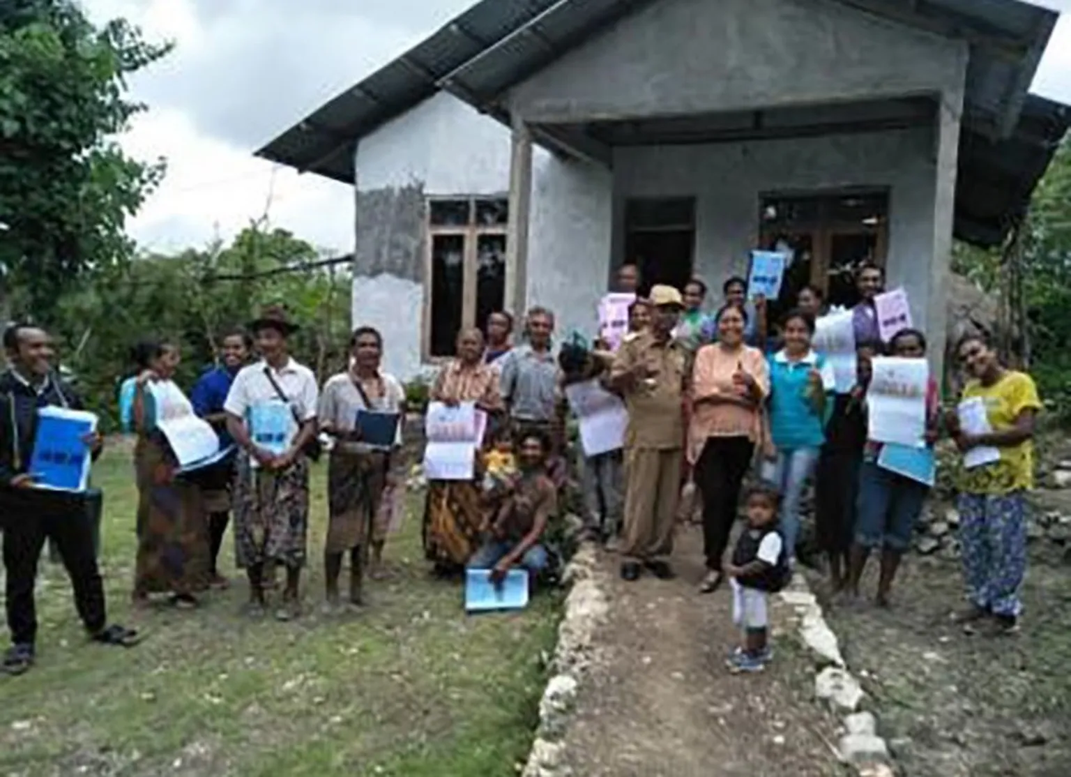 Marni poses with a group of farmers after a training