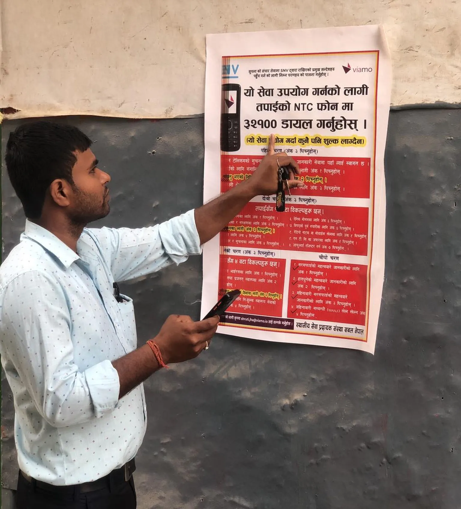 Poster in Saptari Nepal pointing residents into the direction of digital information platforms for COVID and MHH advice (Photo: Parmeshwar Jha, Sabal Nepal)
