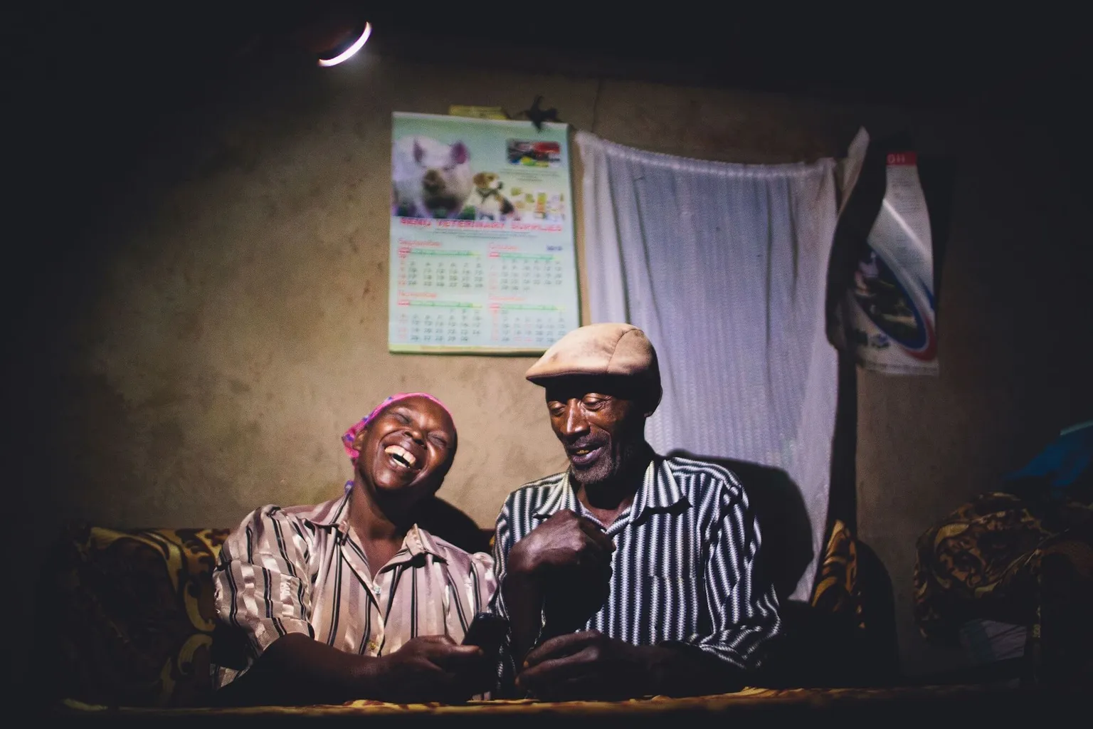 Couple using a biogas lamp 
