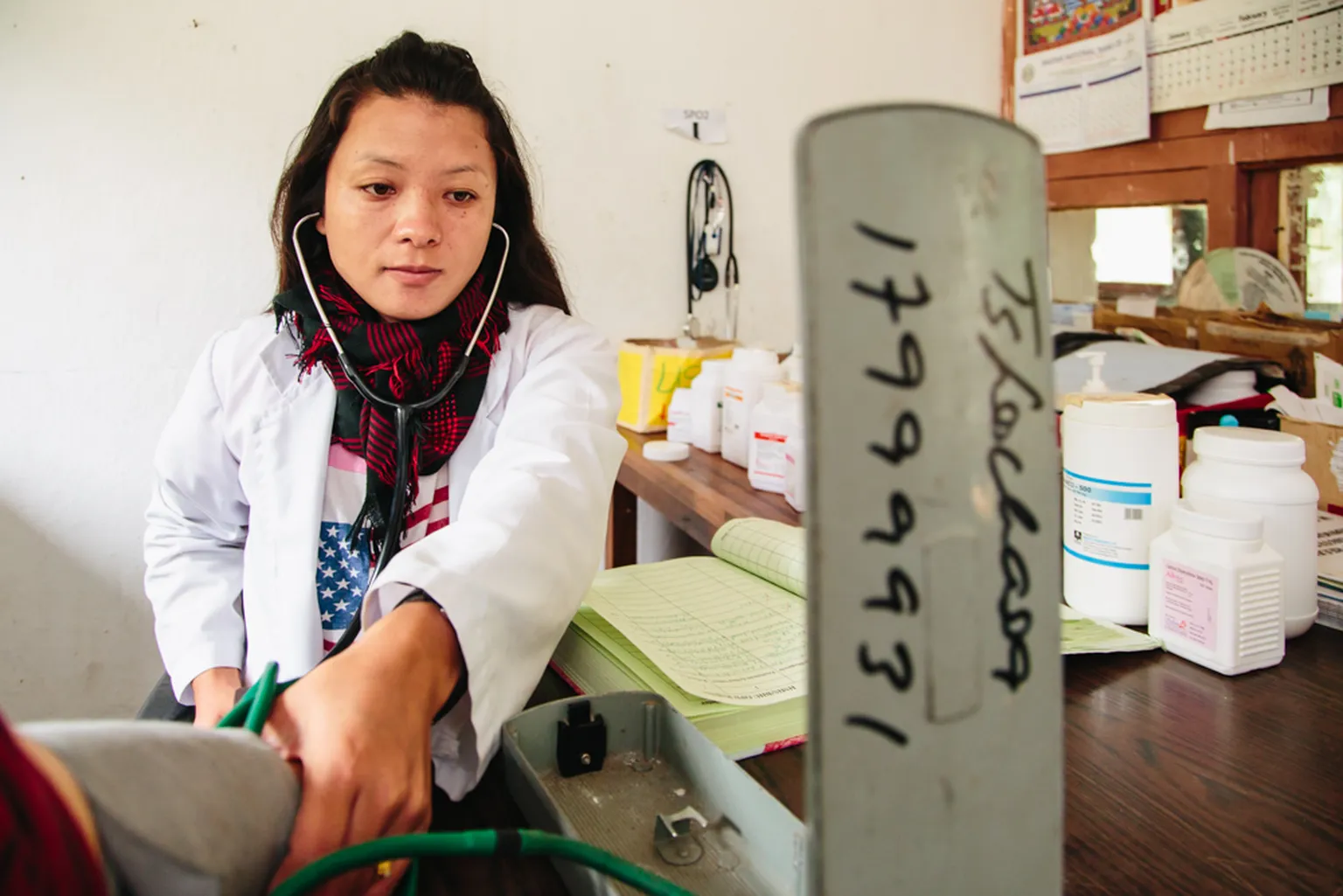 Nurse in Punakha, Bhutan takes patient's blood pressure