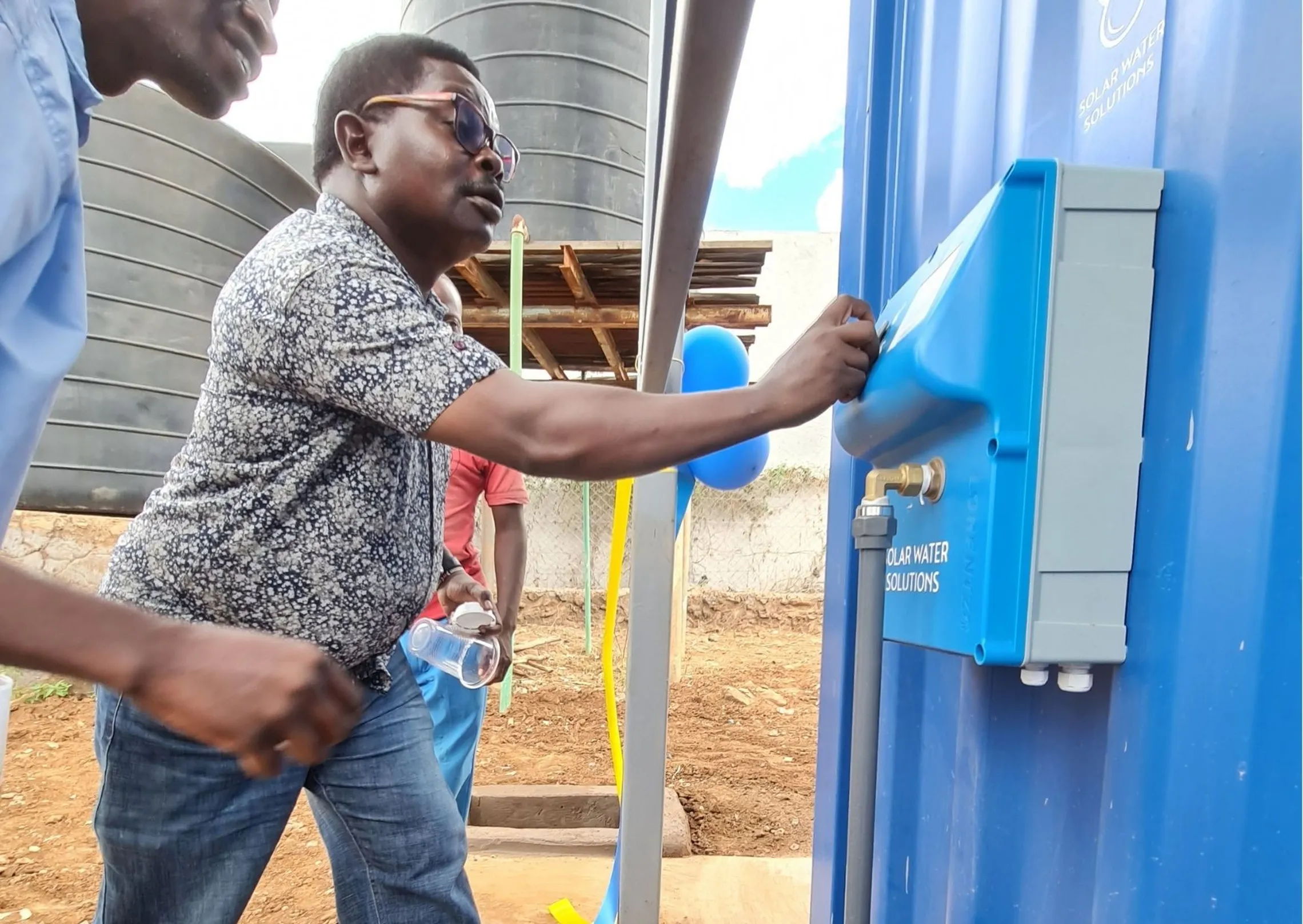 Mr. Emmanuel Kalunda, Assistant director of Education Kitui County adraws water from the unit