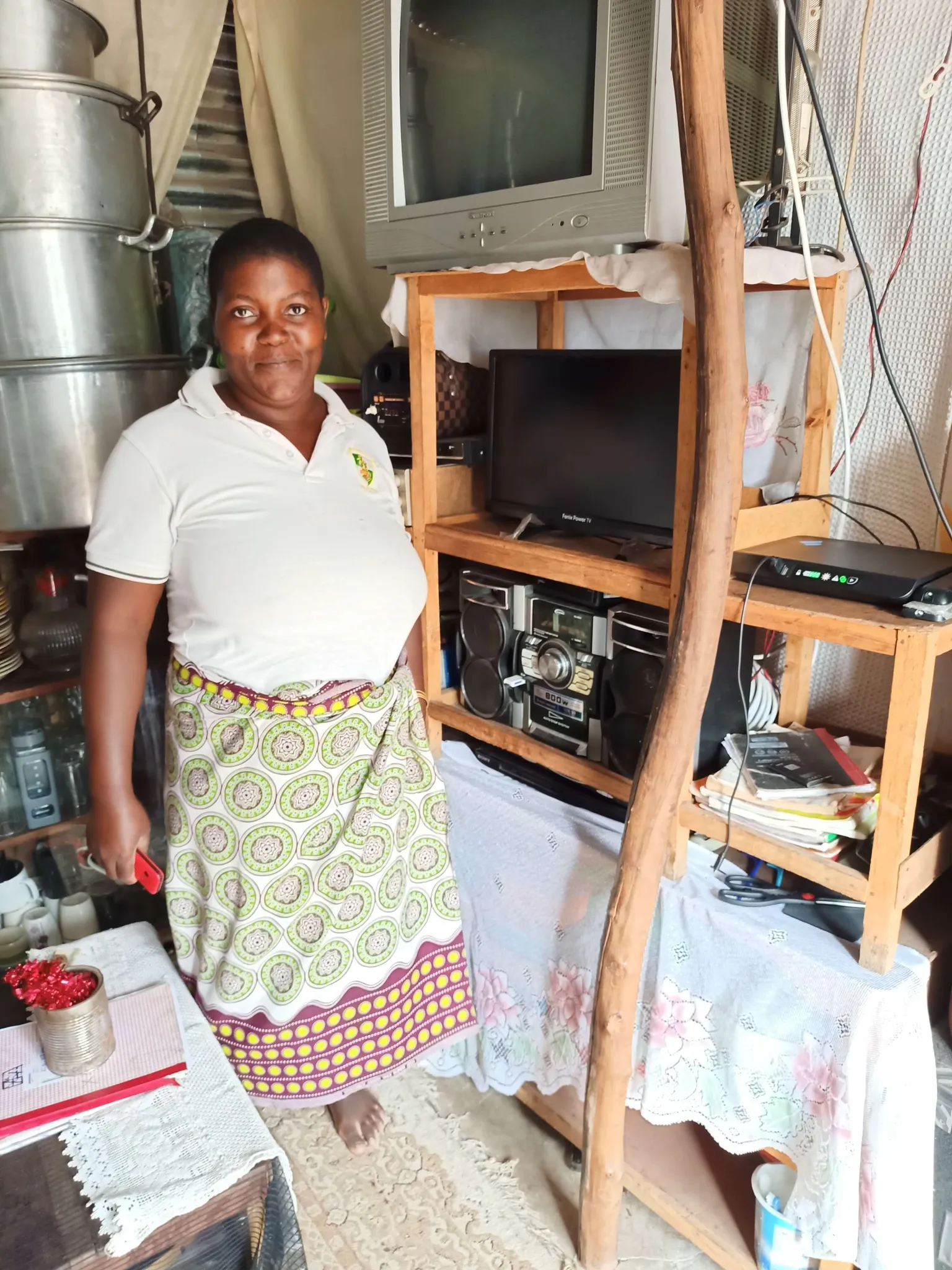 lady in her home with solar home system