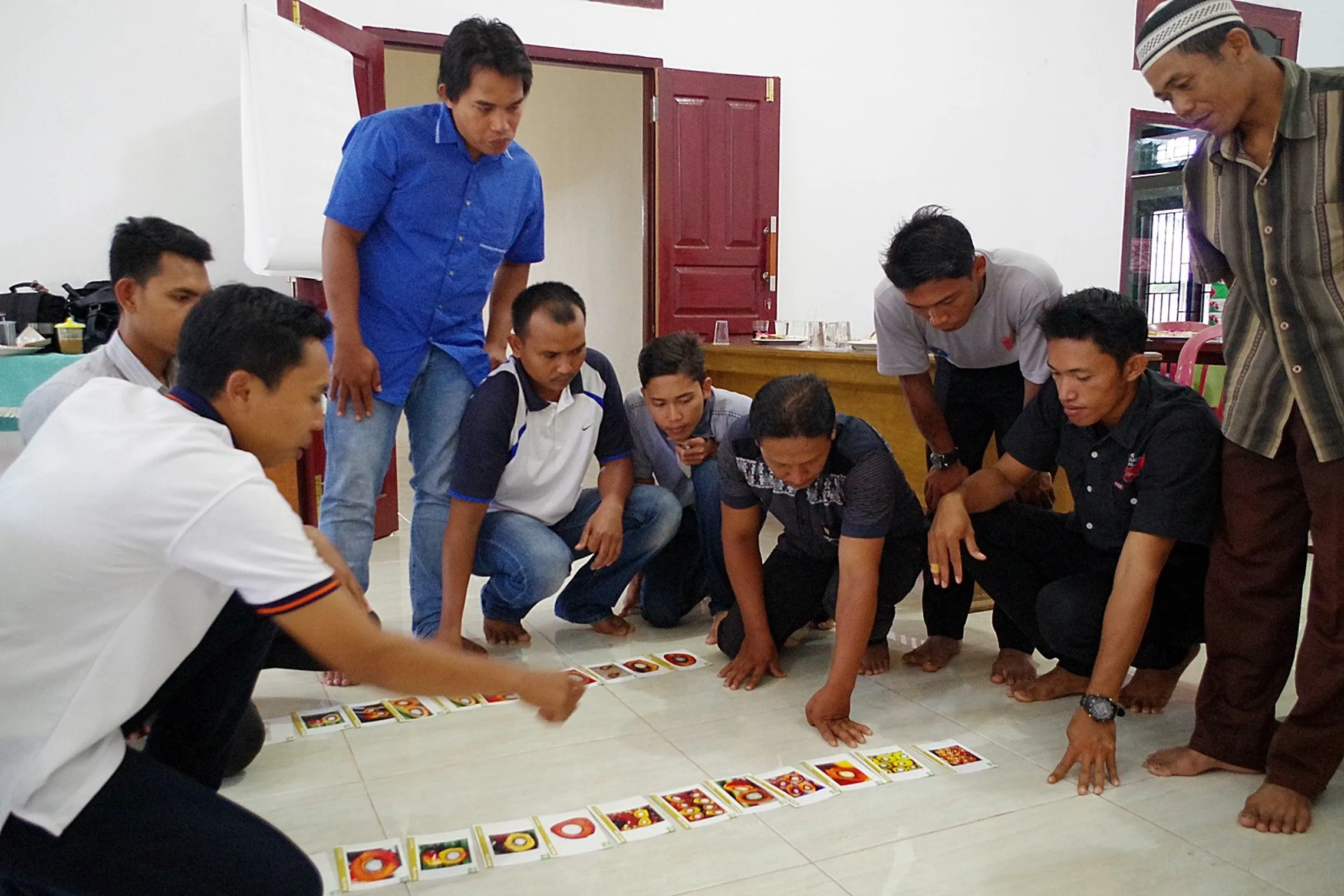 Mr. Sufyan leads a game that helps identify the best palm oil seeds