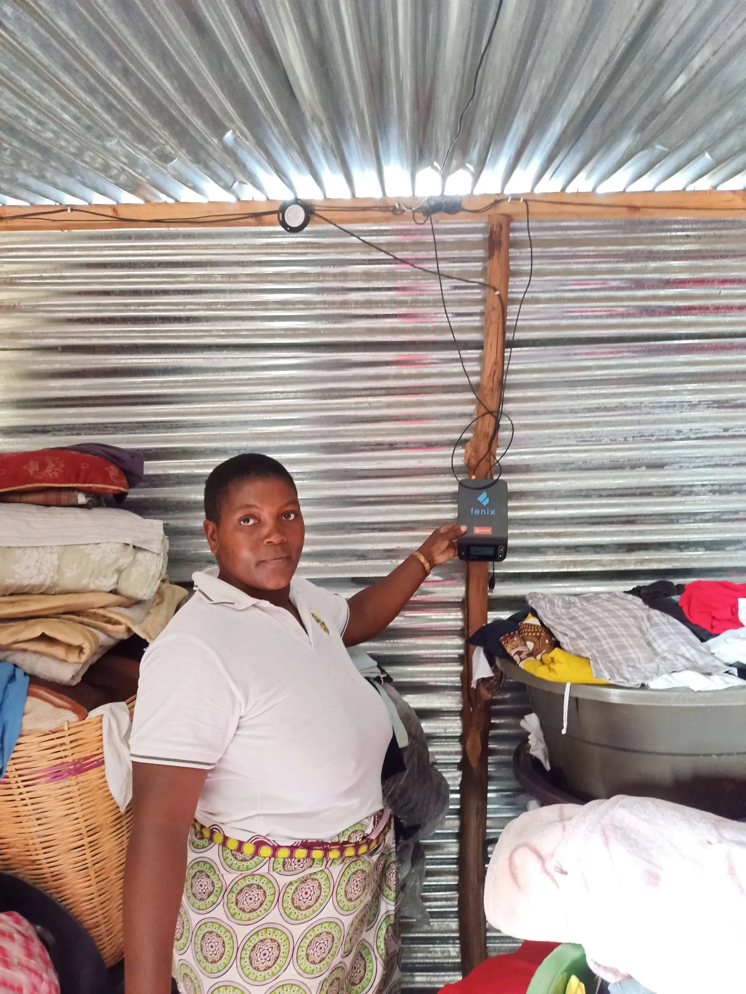 A lady demonstrating her solar home system