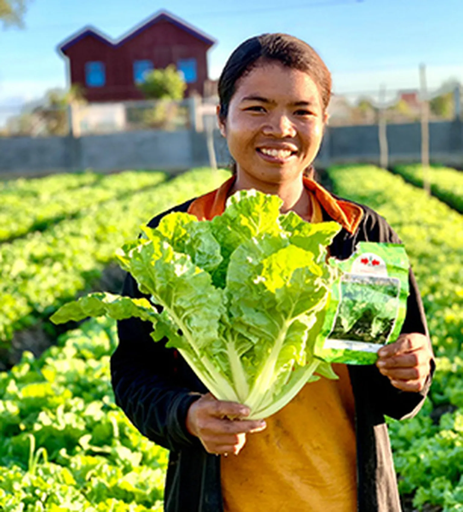 A photo of a young man holding a lettuce