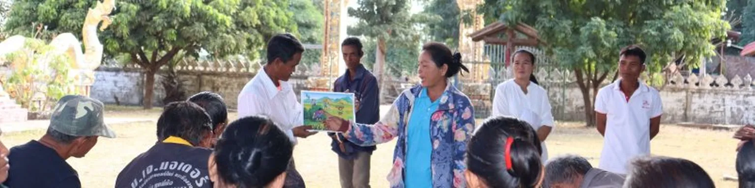 Lady showing an image to a set of people.