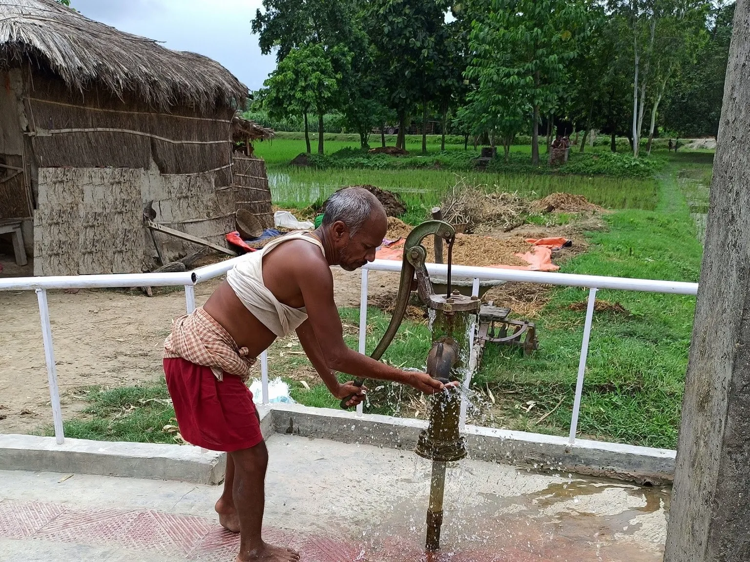 Person with disability uses handpump in Ramnagar municipality