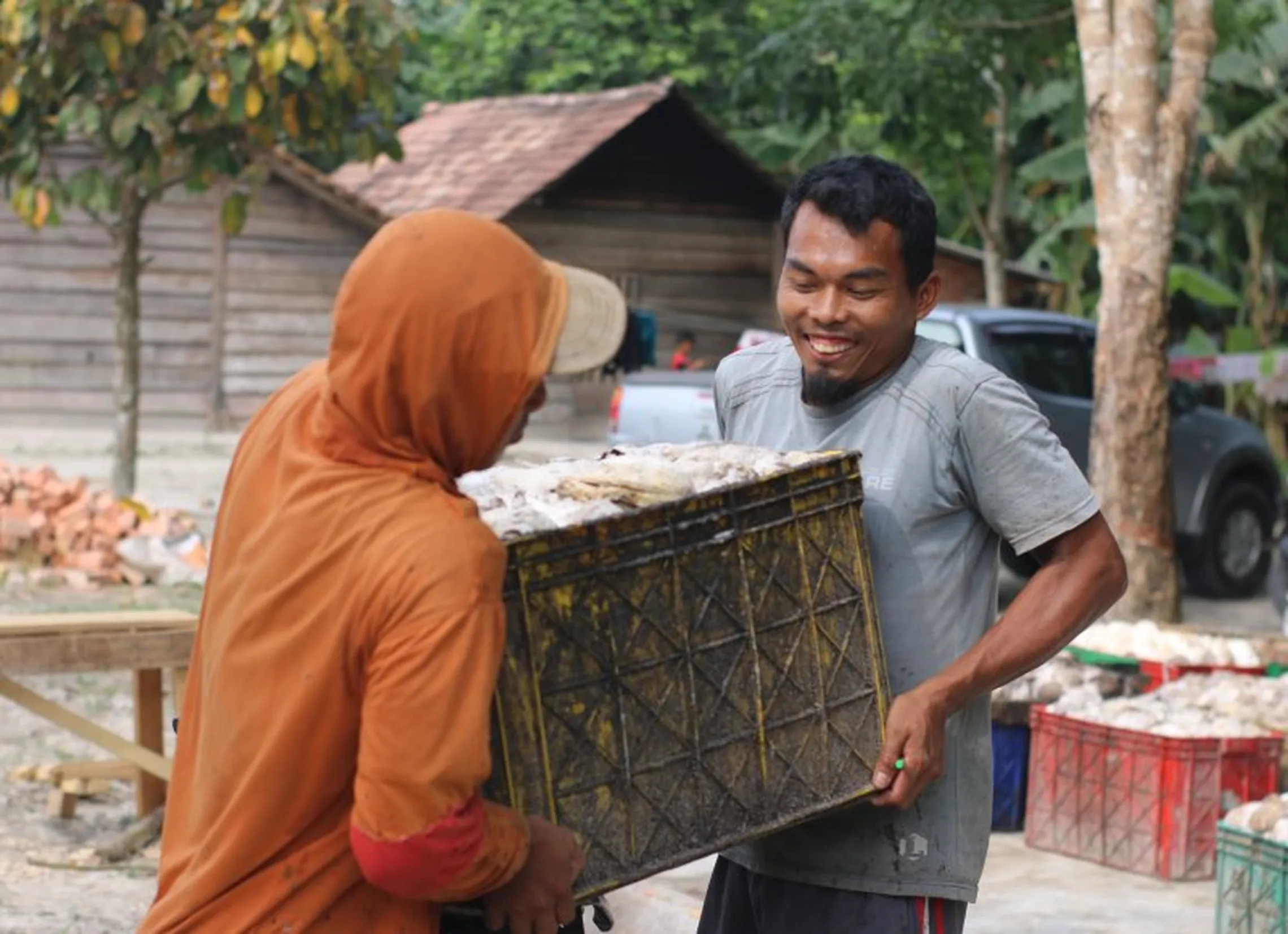 Joko lifts a crate of latex cubes for a processing company (P.C.Gilang A Riva’i)