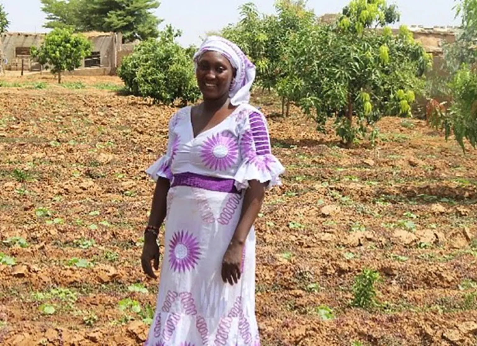 Mariam on her new plot with cucumbers