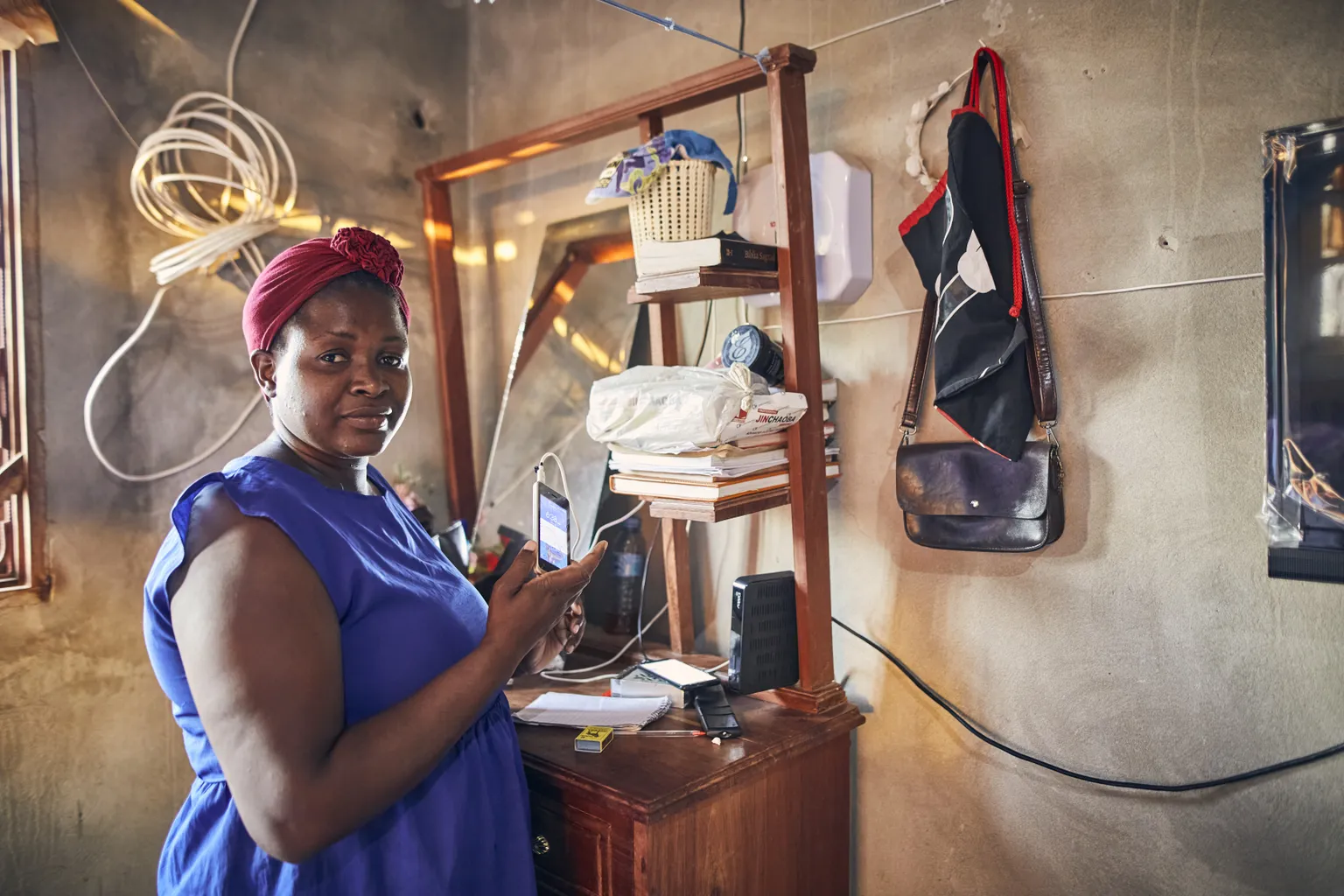 A woman charges her mobile phone