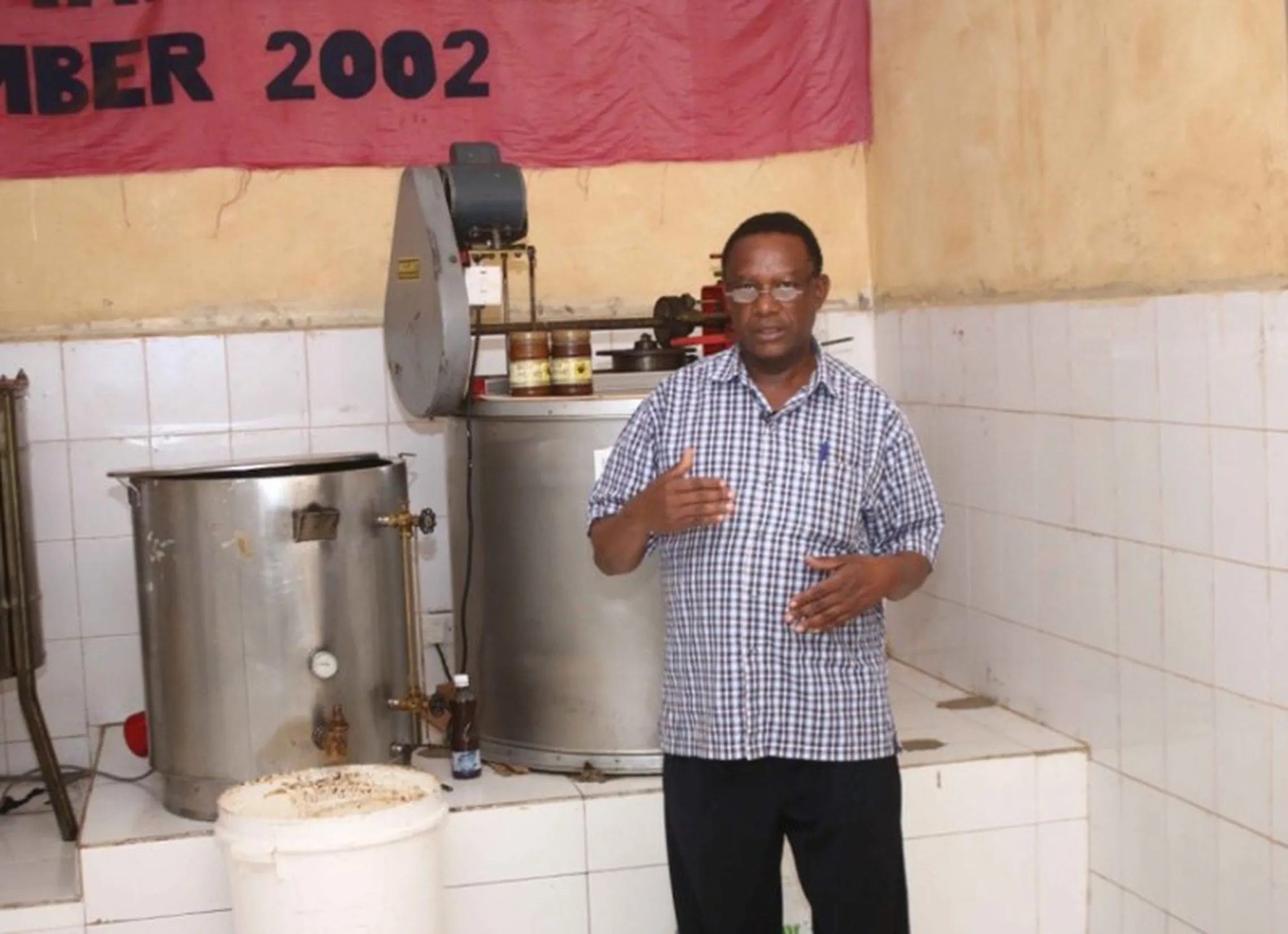 David Kilonzi explaining about the honey processing equipment 