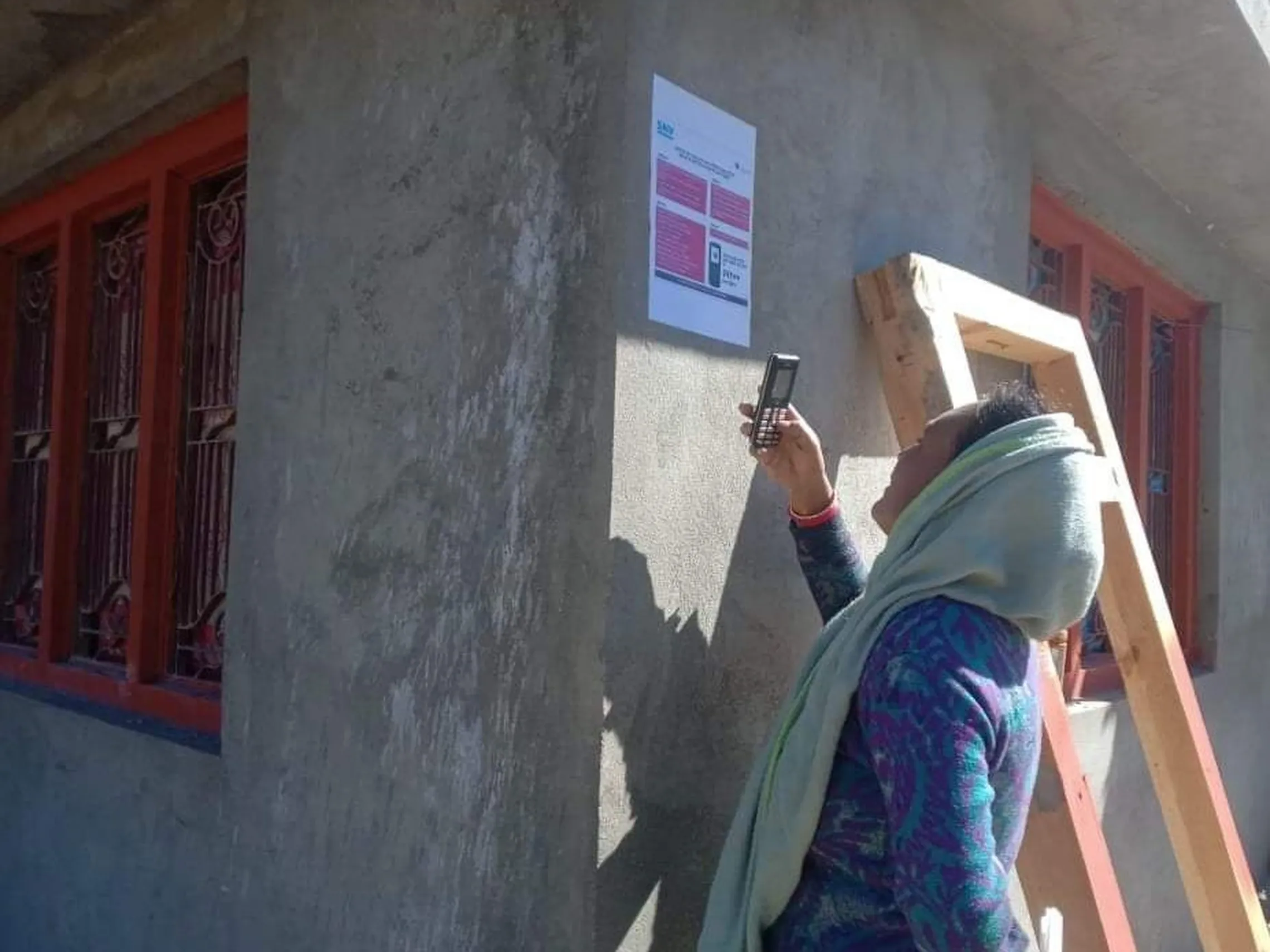 Woman from Jumla dials 32100 to receive info on COVID/MHH (Photo: Nandalal Dharala/SNV Nepal)