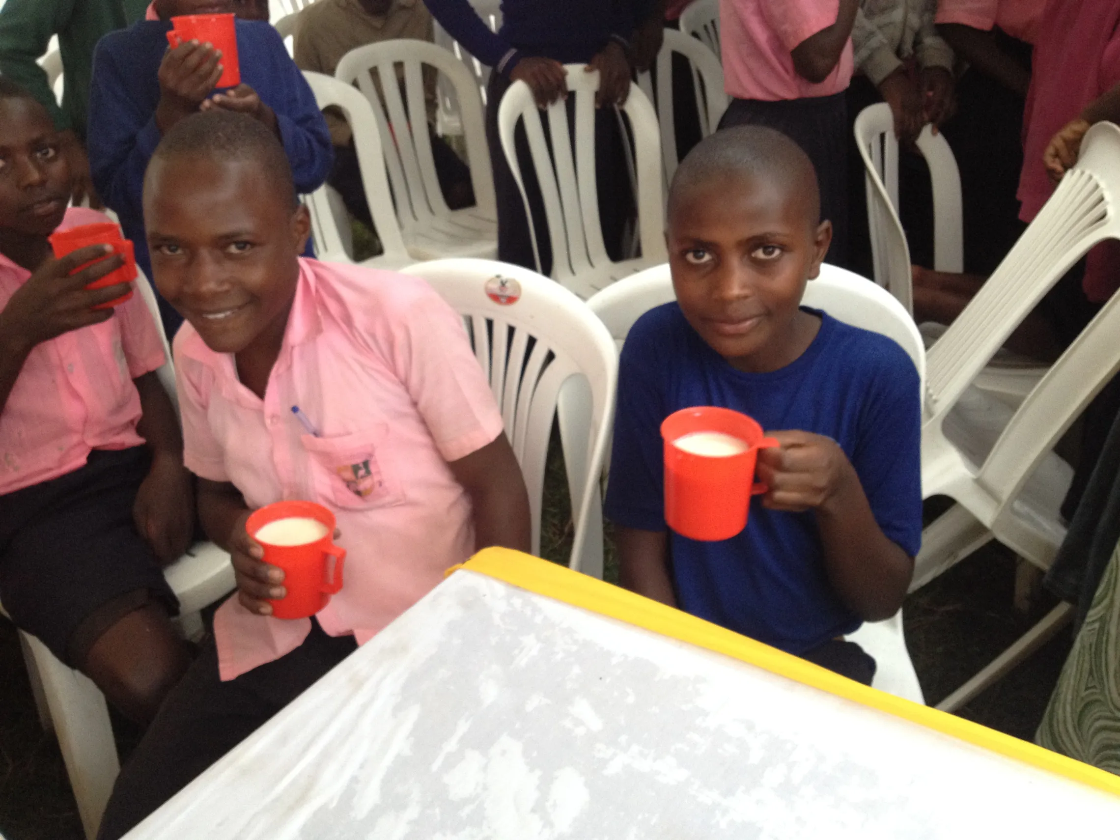 Happy students of Kagamba primary school enjoy milk