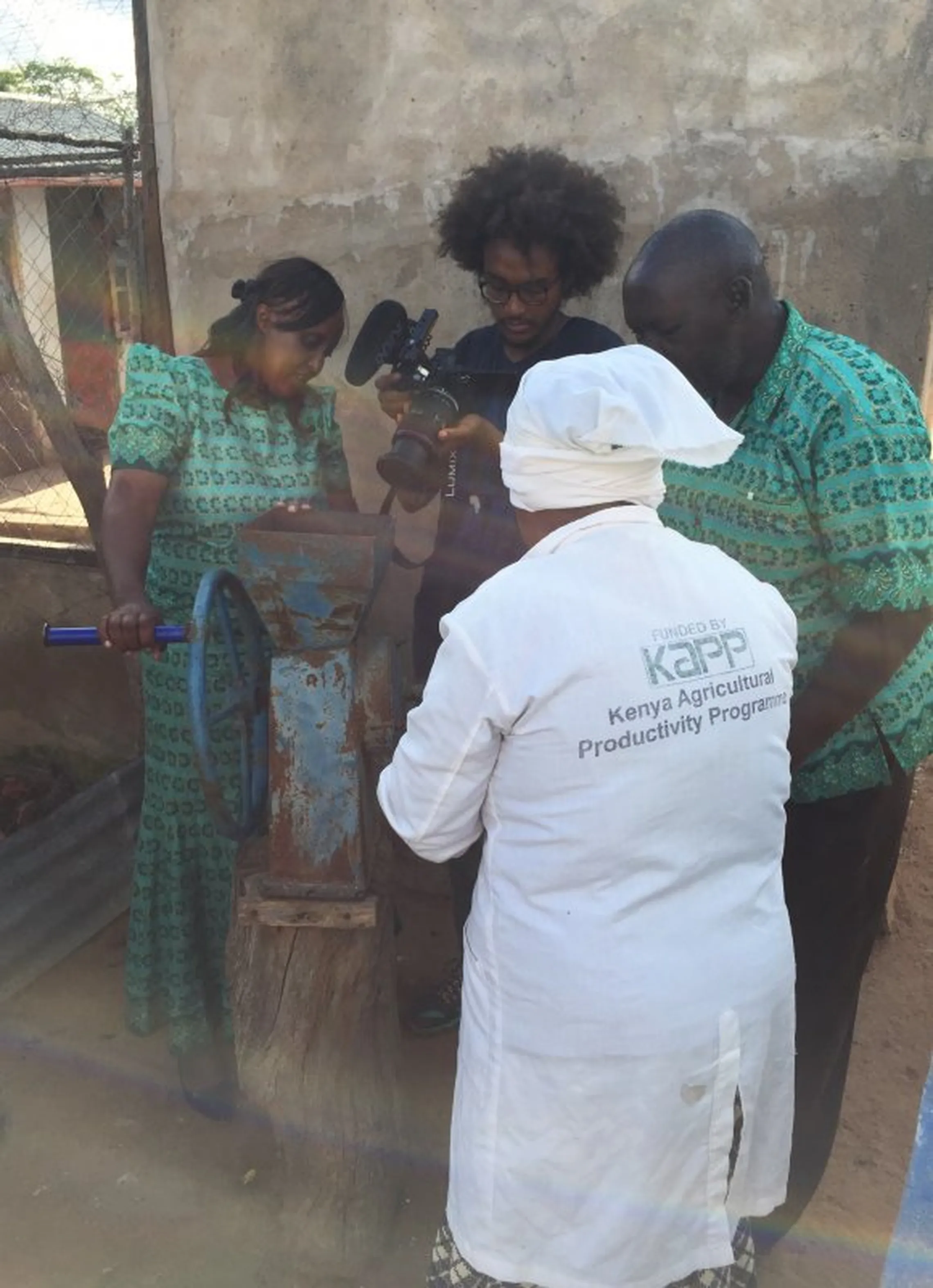 Women’s group member in Makueni demonstrates how they grind and mix chicken feed