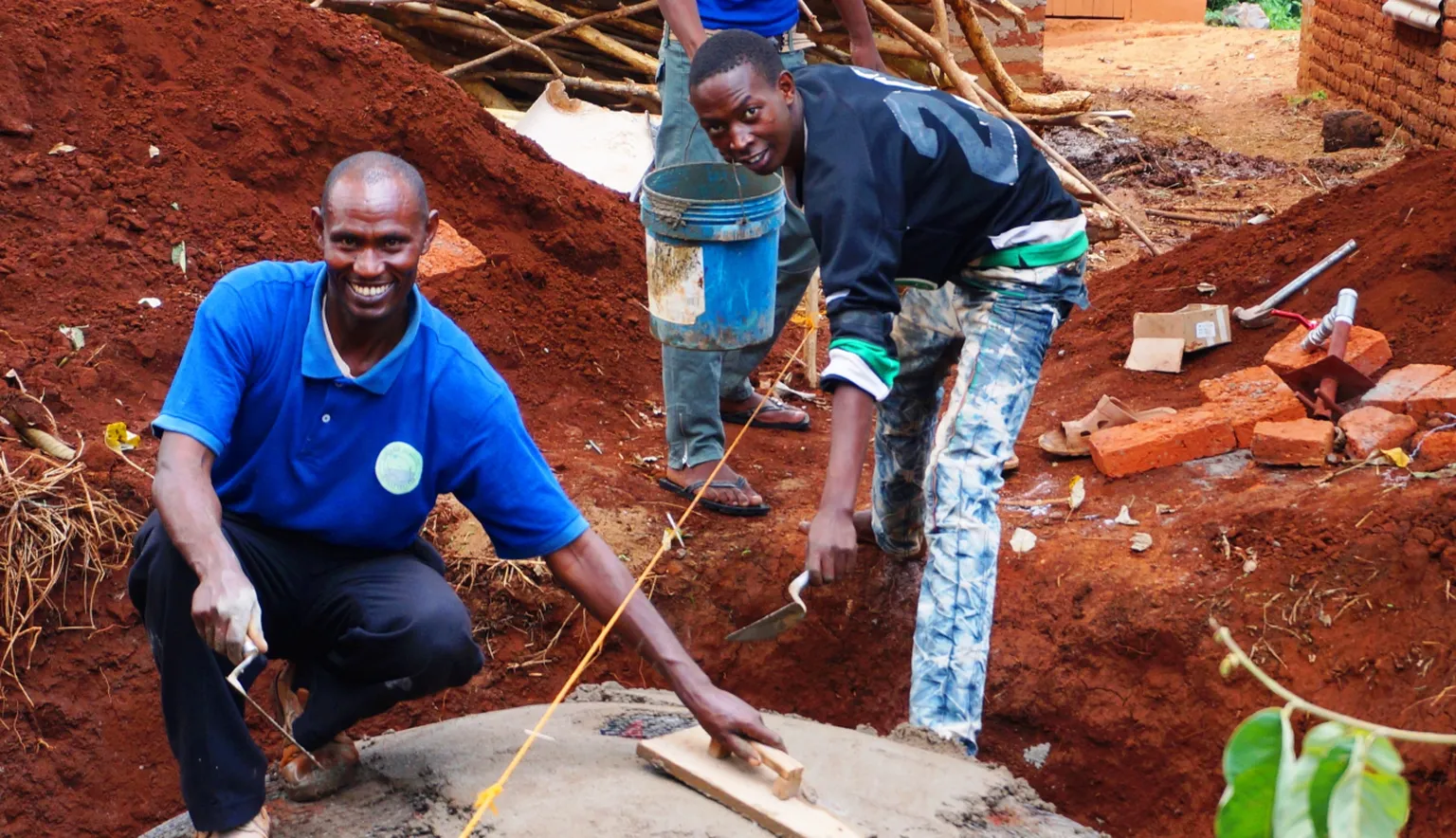 Youth building a digester