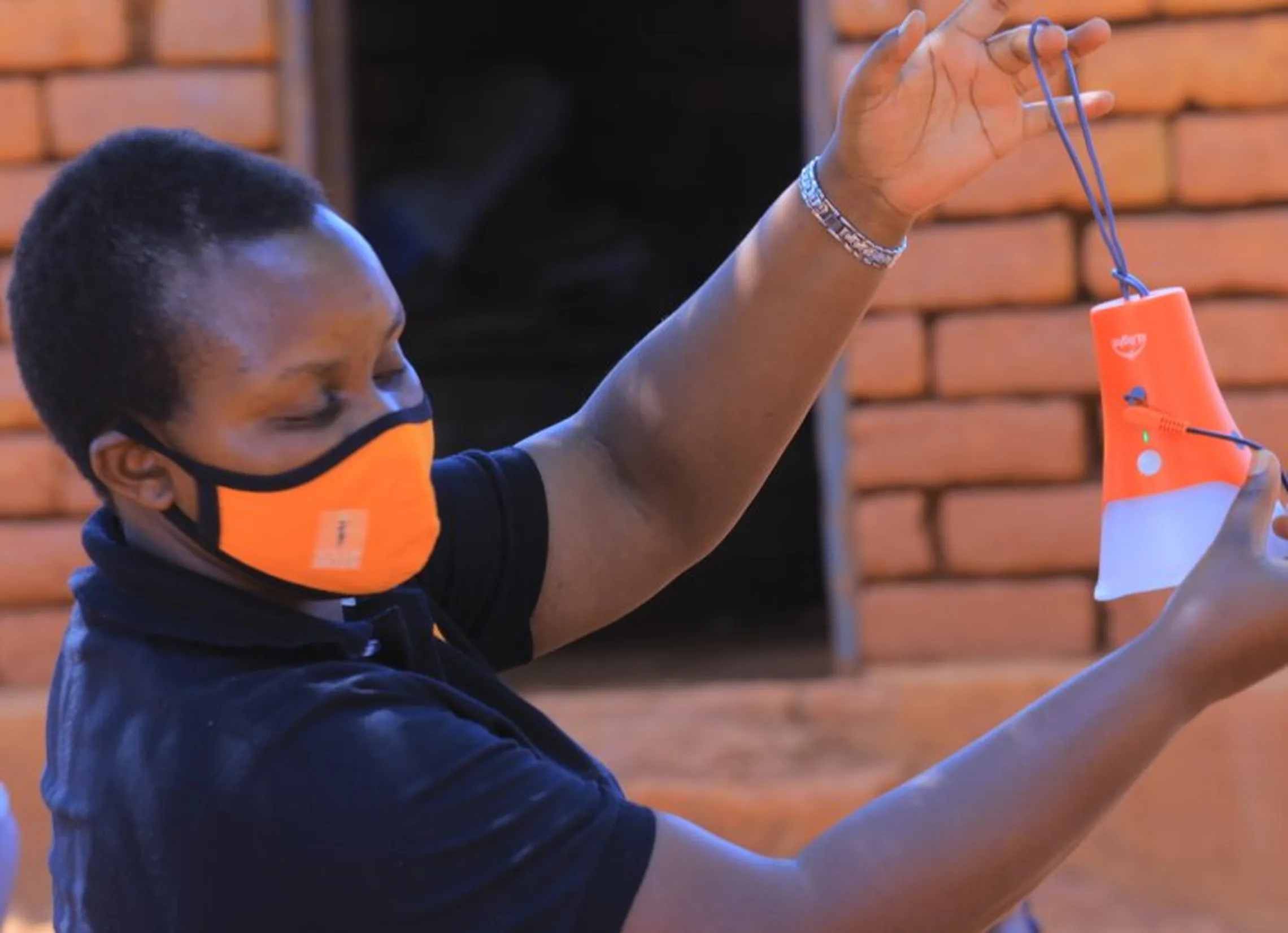 Queen demonstrates product features of a solar light