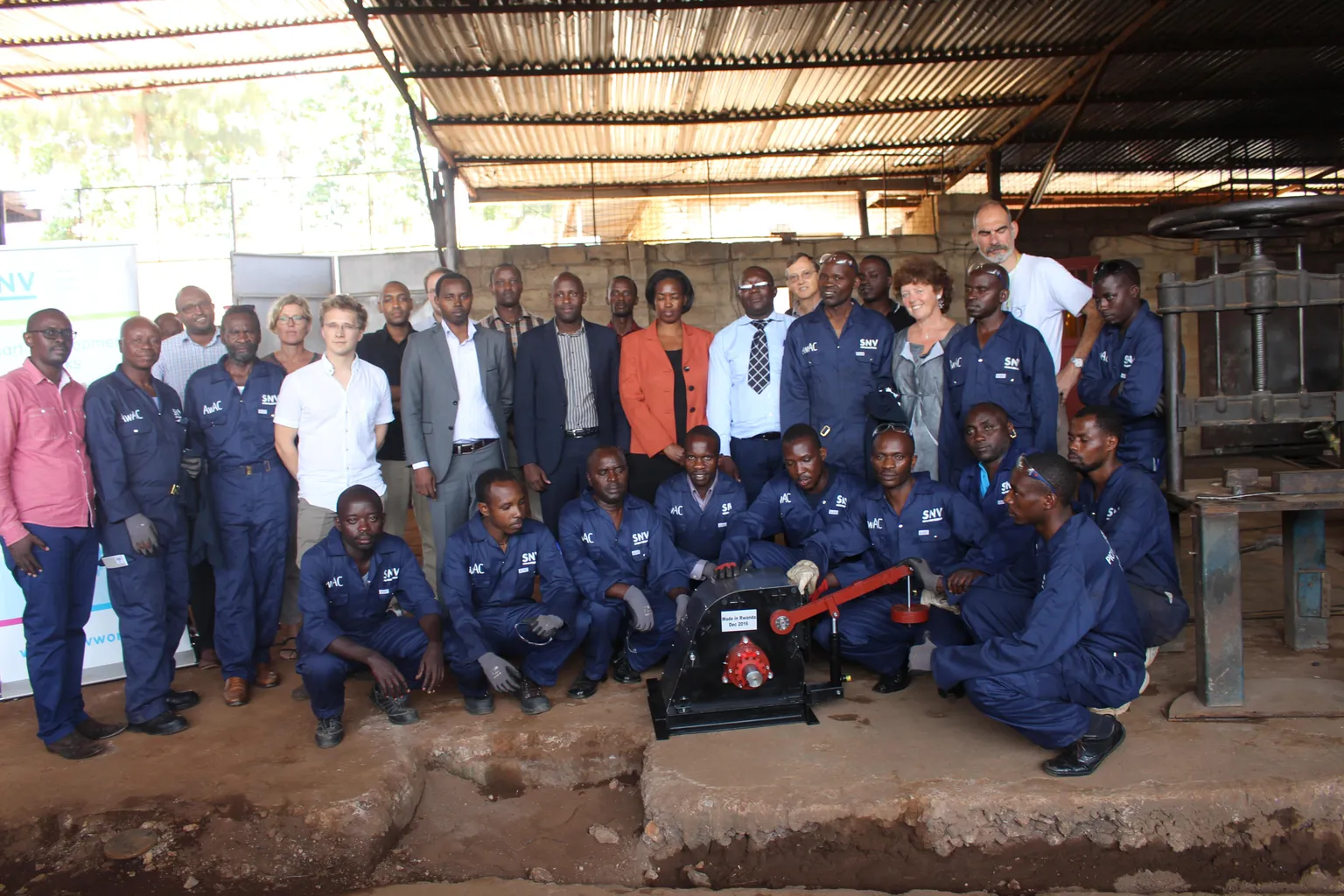 Technicians pose for a photo with SNV staff and their trainers after training