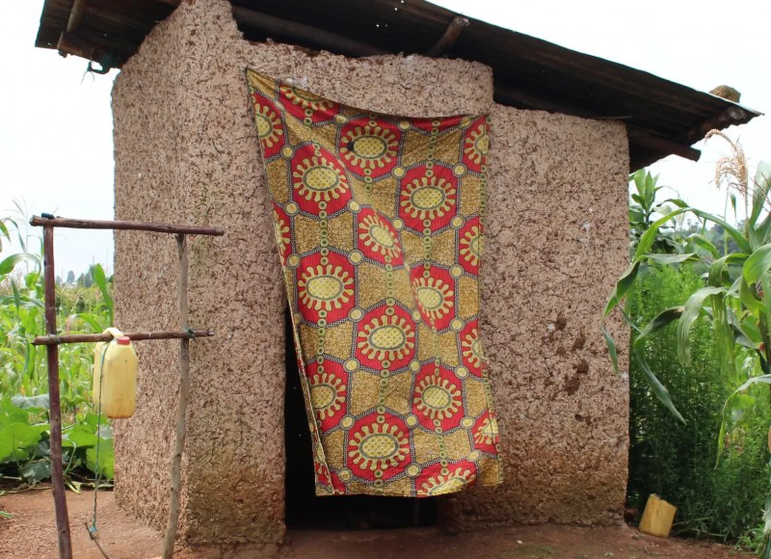 Mukamutesi’s newly improved latrine with a hand-washing station.